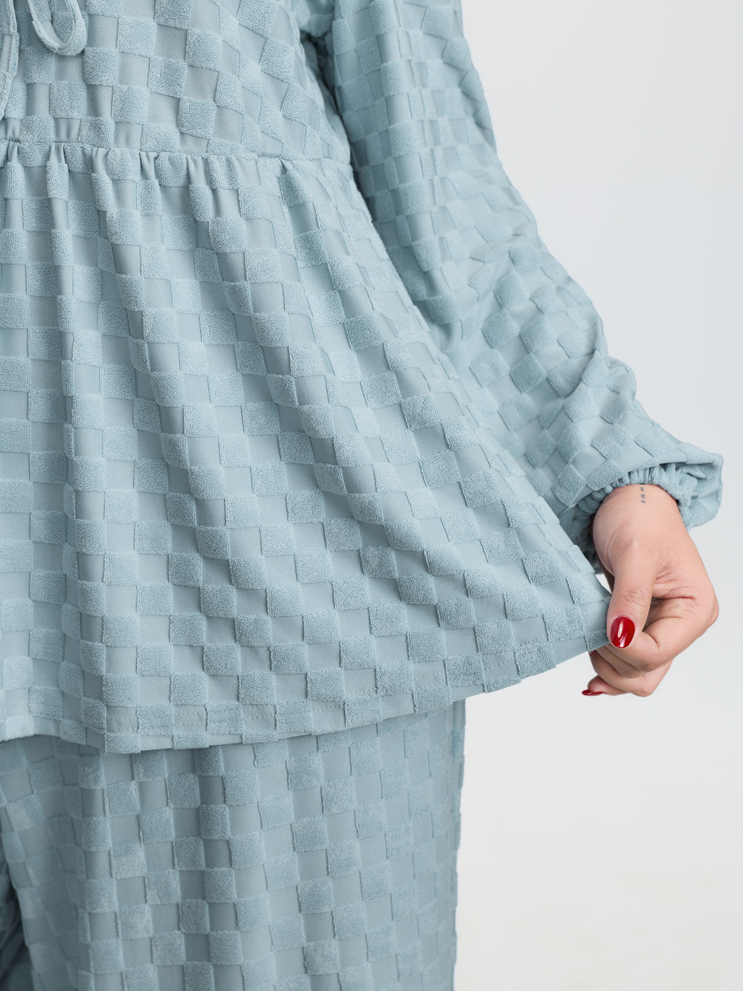 Side view of BloomChic Women's Plus Size Checkered Textured Co-ord Lounge Set LightBlue Solid Long Sleeve Smocked 22-24/3X