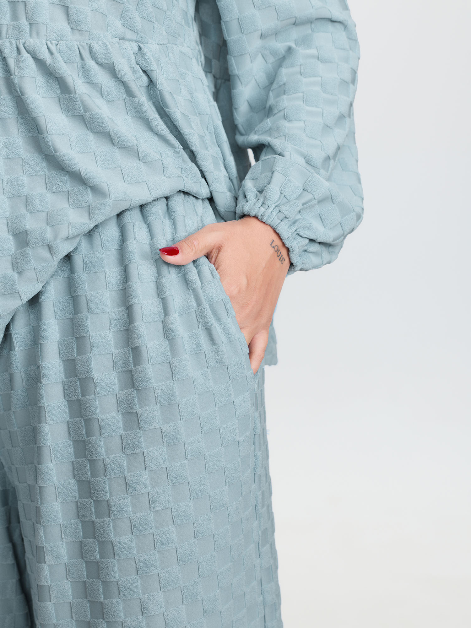 Side view of BloomChic Women's Plus Size Checkered Textured Co-ord Lounge Set LightBlue Solid Long Sleeve Smocked 22-24/3X