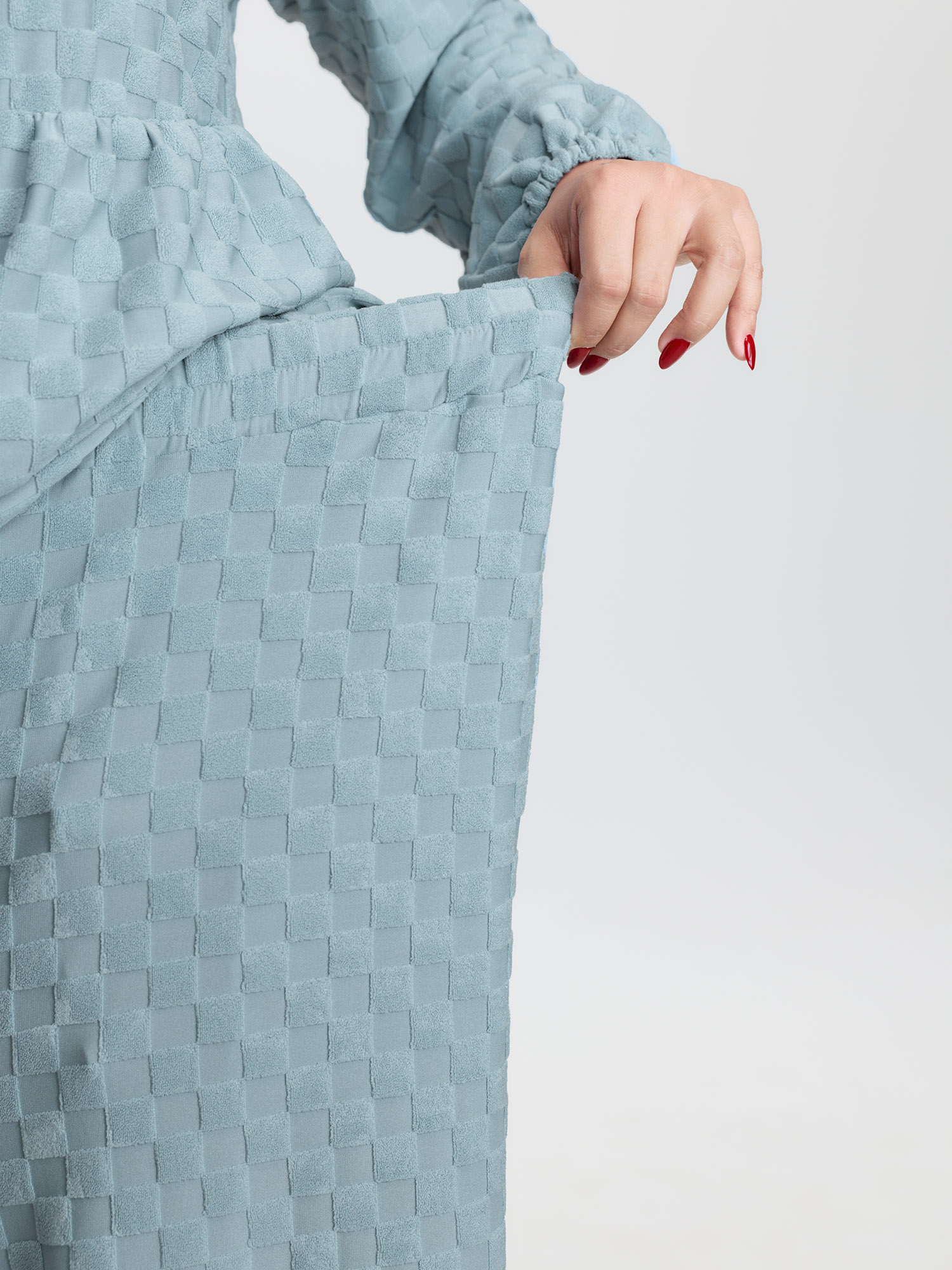 Side view of BloomChic Women's Plus Size Checkered Textured Co-ord Lounge Set LightBlue Solid Long Sleeve Smocked 22-24/3X