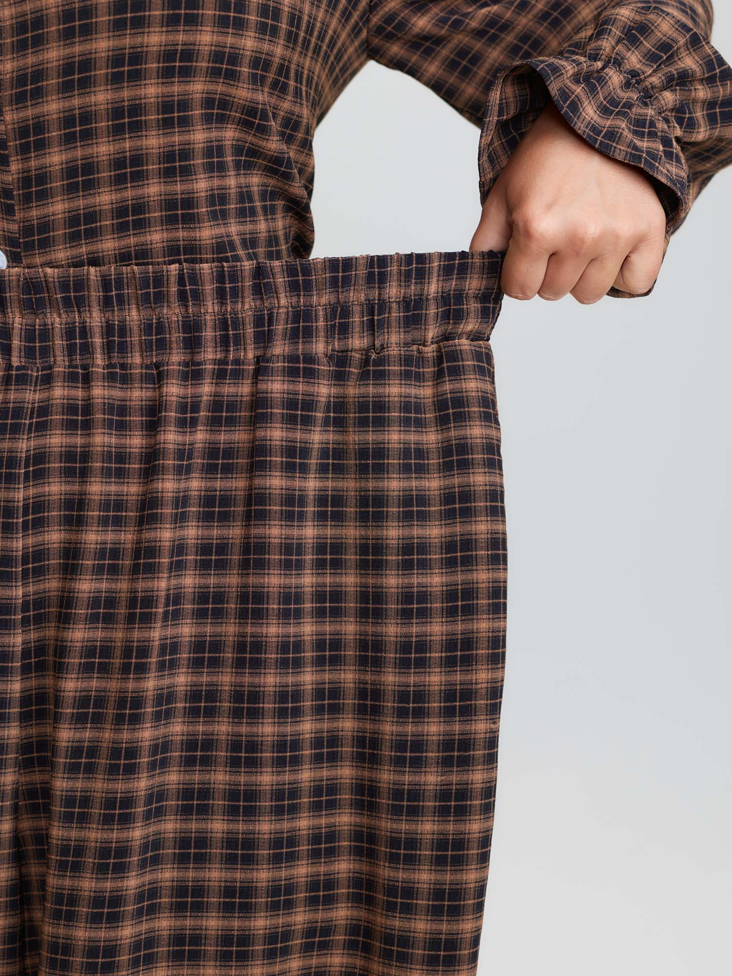 Side view of BloomChic Women's Plus Size Gingham Print Ruffled Hem Co-Ord Pajama Set Rust not graphics 28/5X