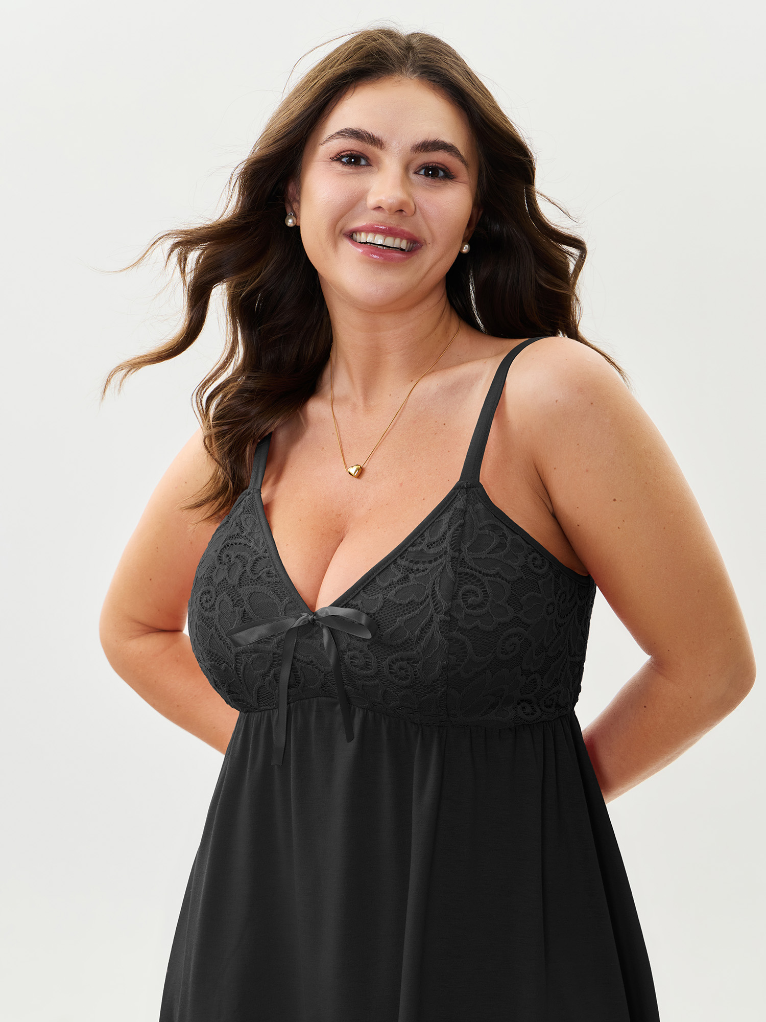 Side view of BloomChic Women's Plus Size Bowknot Crochet Lace Asymmetrical Hem Nightgown Black Sleeveless Tunic V-Neck 14-16/1X