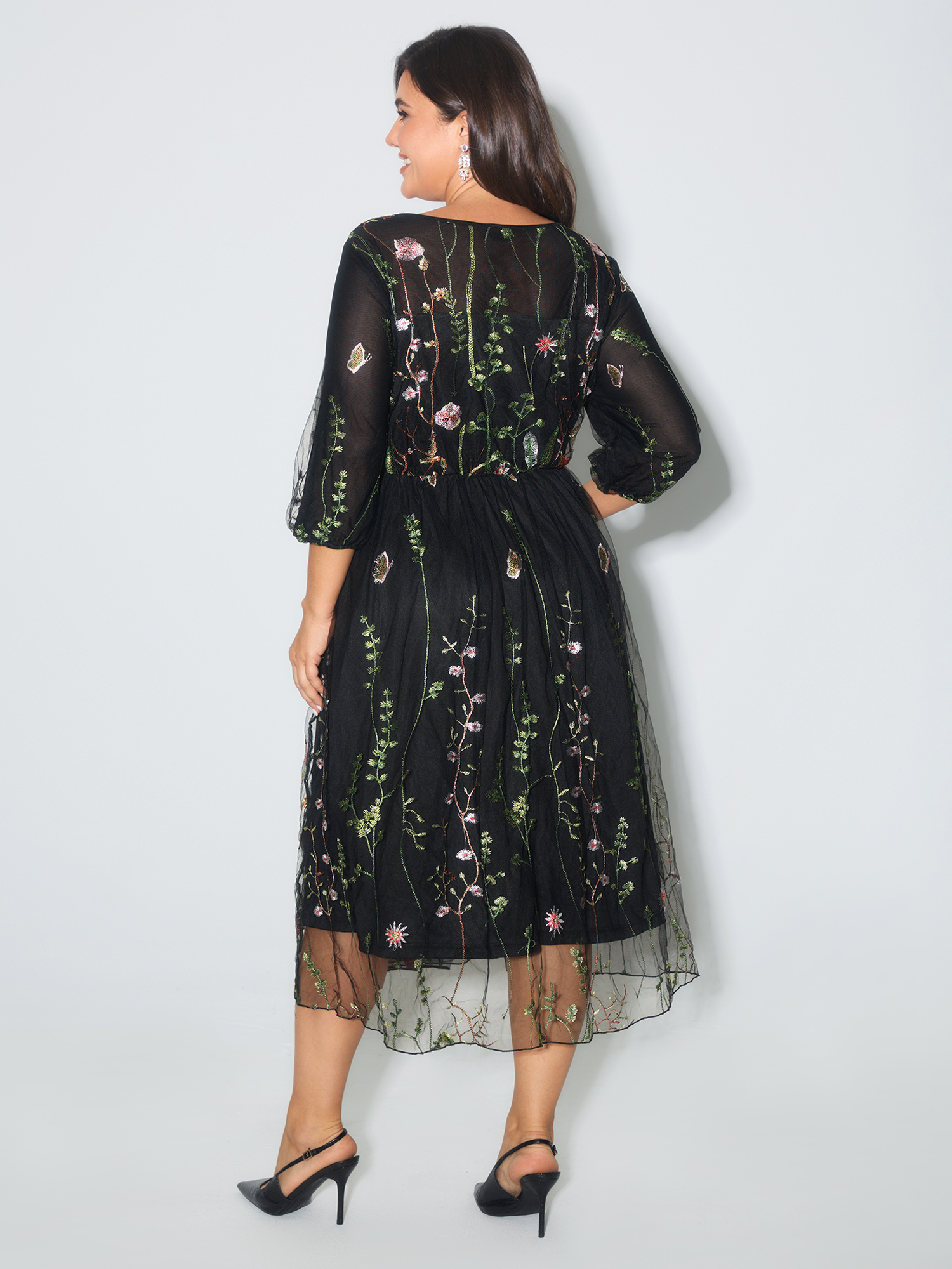 Side view of BloomChic Women's Plus Size Floral Embroidered Elastic Waist Lined Midi Dress Black Party Midi Mesh Panel Round Neck 12/L