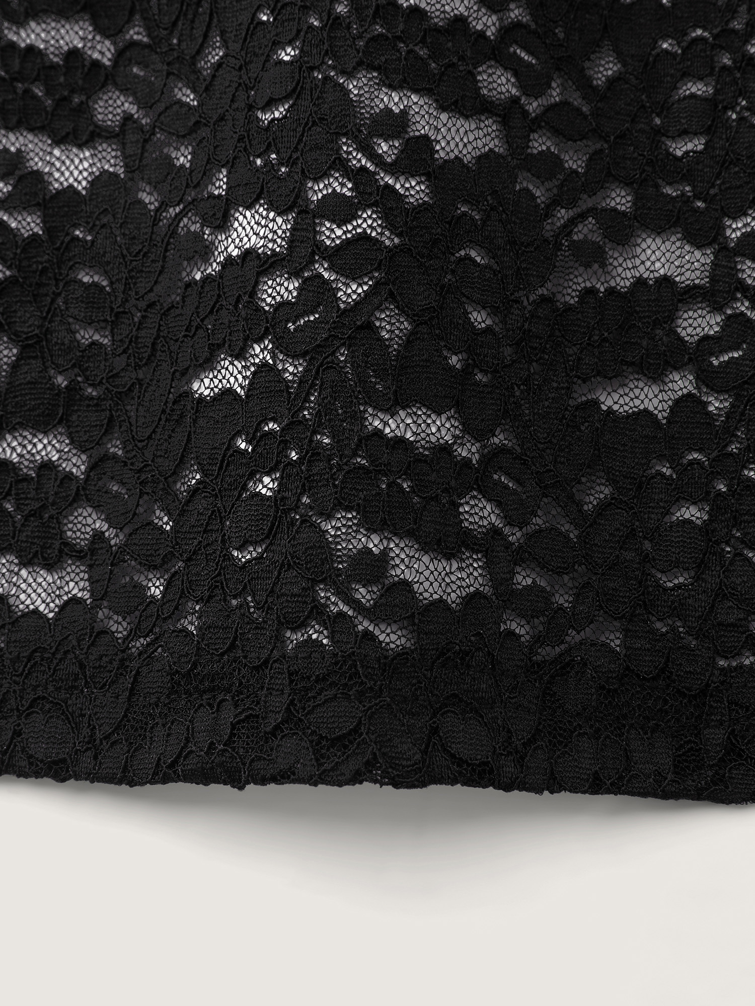 Side view of BloomChic Women's Plus Size Sheer Lace Textured Crosstie Nightgown Black Sleeveless Tunic 26/4X