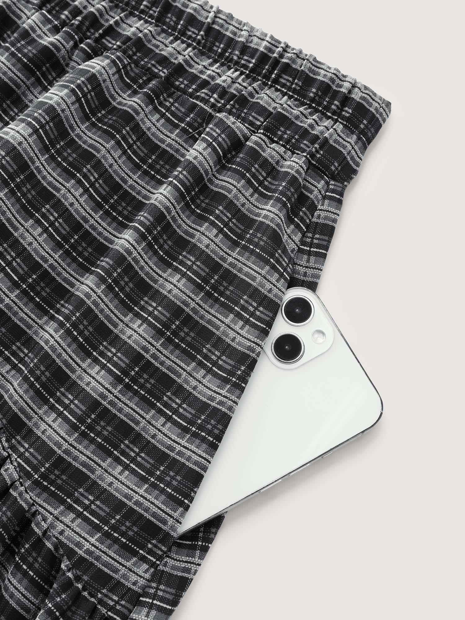 Side view of BloomChic Women's Plus Size Checkered High-Low Hem Maxi Skirt Black Gathered Flared Casual 30/6X