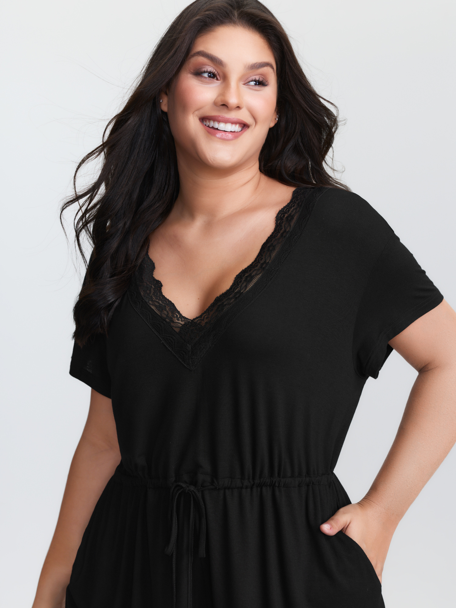 Side view of BloomChic Women's Plus Size Supersoft Lace Neckline Pajama Romper Pureblack Tunic 26/4X