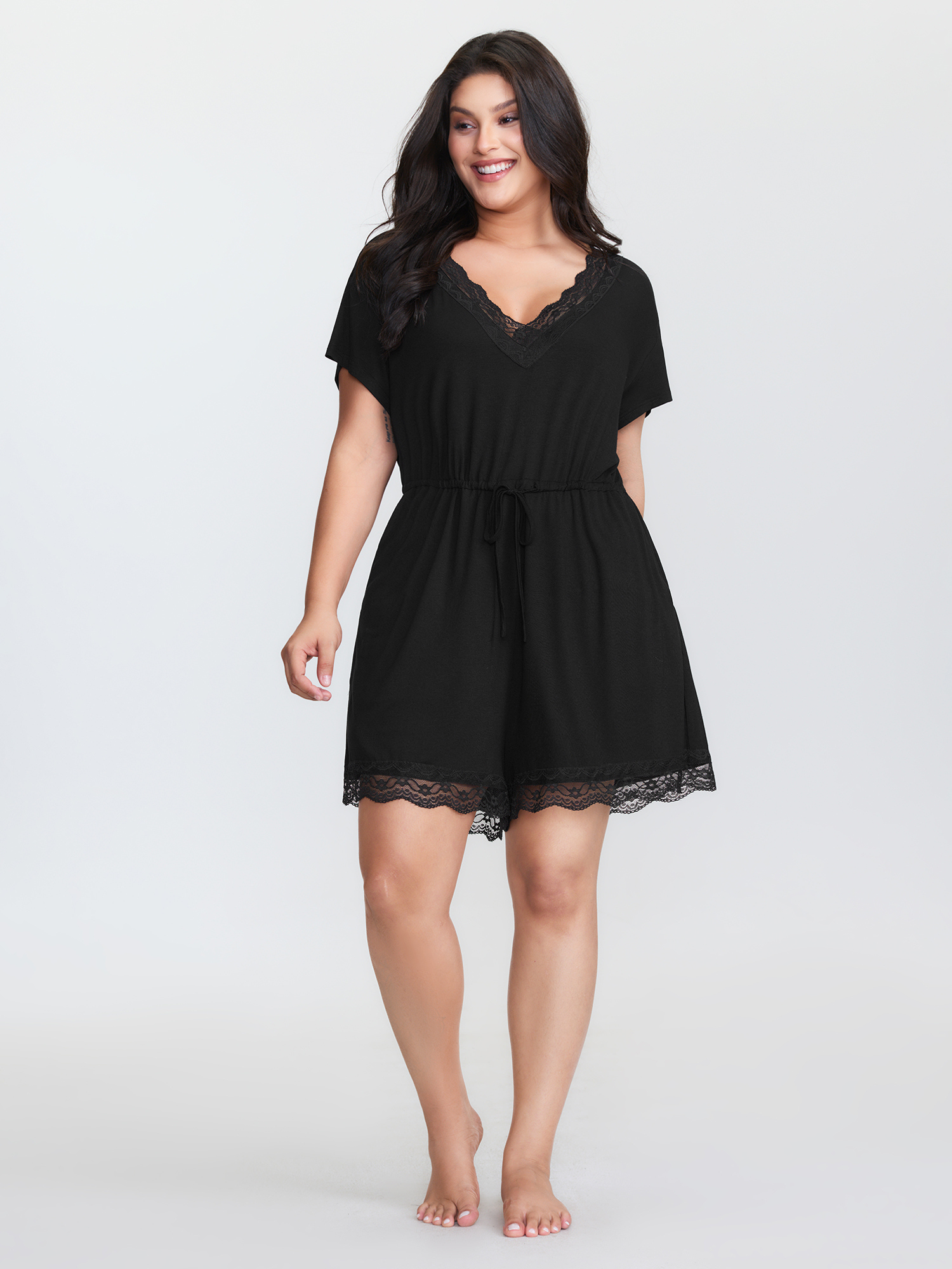 Side view of BloomChic Women's Plus Size Supersoft Lace Neckline Pajama Romper Pureblack Tunic 26/4X