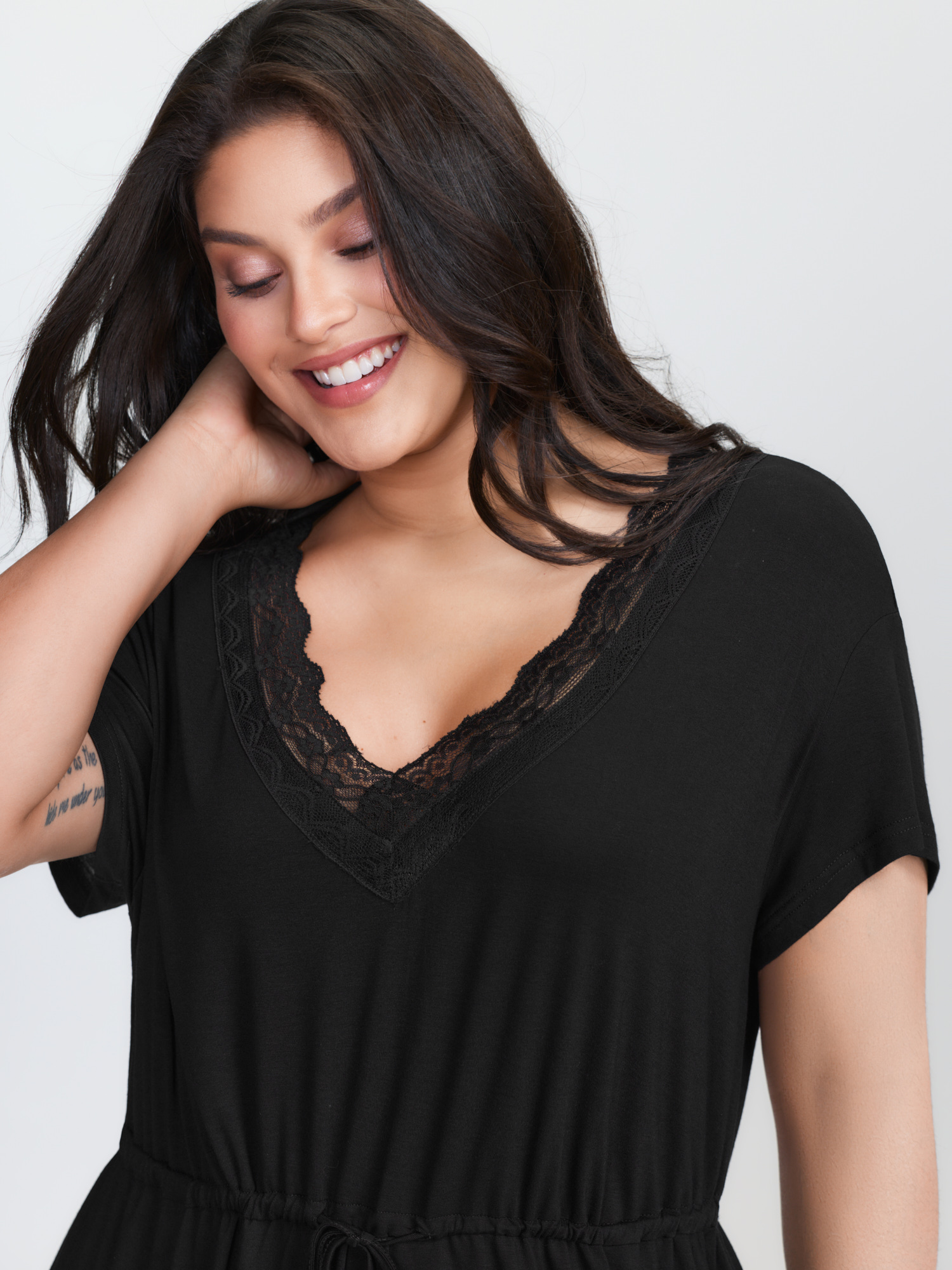 Side view of BloomChic Women's Plus Size Supersoft Lace Neckline Pajama Romper Pureblack Tunic 26/4X