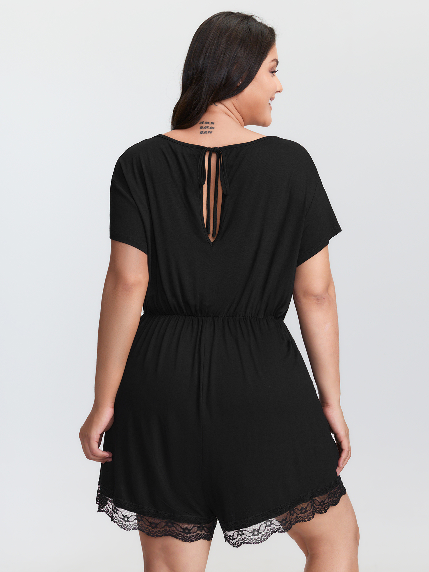 Side view of BloomChic Women's Plus Size Supersoft Lace Neckline Pajama Romper Pureblack Tunic 26/4X