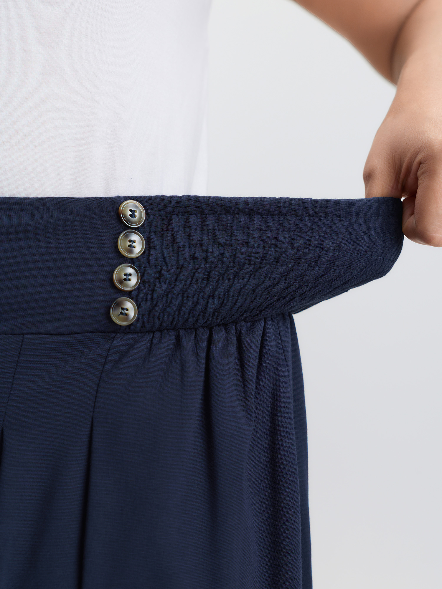 Side view of BloomChic Women's Plus Size Supersoft Shirred Wide Waistband Button Lounge Bottoms DarkBlue Knee 30/6X