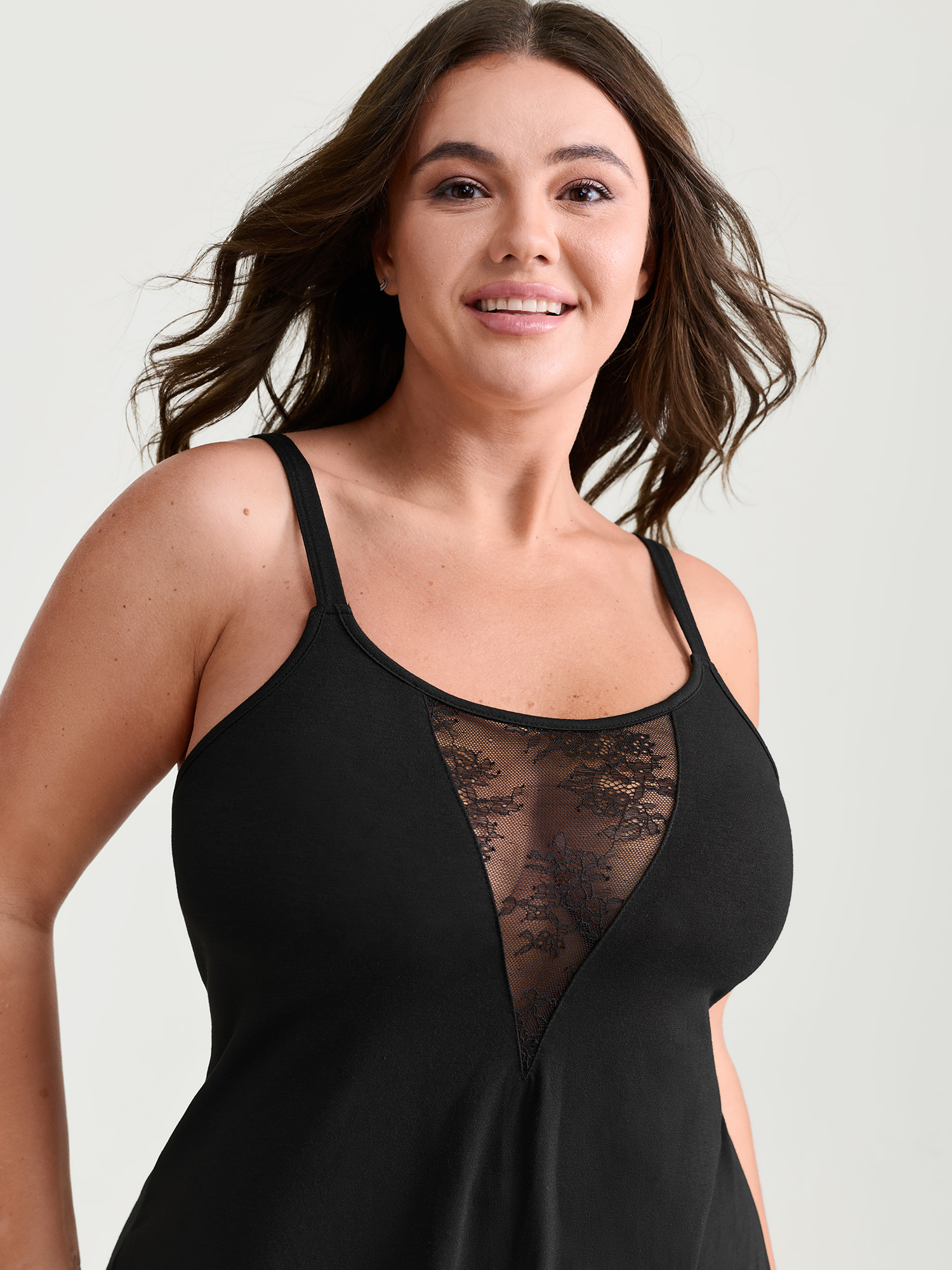 Side view of BloomChic Women's Plus Size Supersoft Sheer Neckline Pockets Nightgown Black Sleeveless Short 12/L