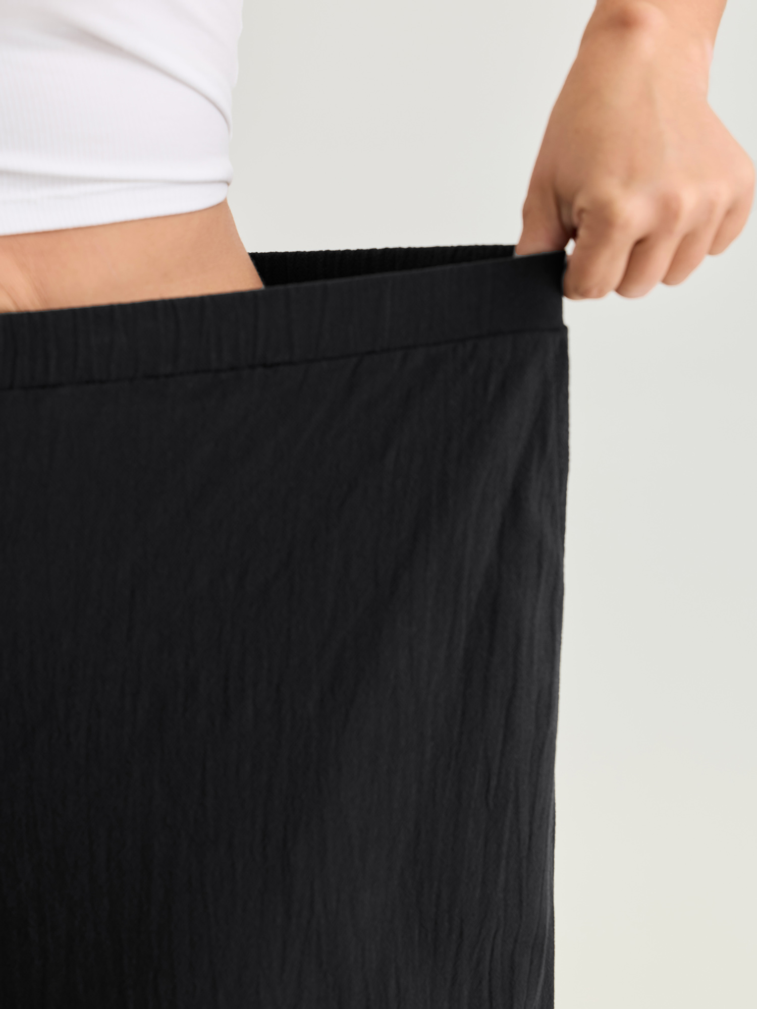Side view of BloomChic Women's Plus Size Pure Cotton Ruffled Hem Lounge Bottoms Black Full 22-24/3X