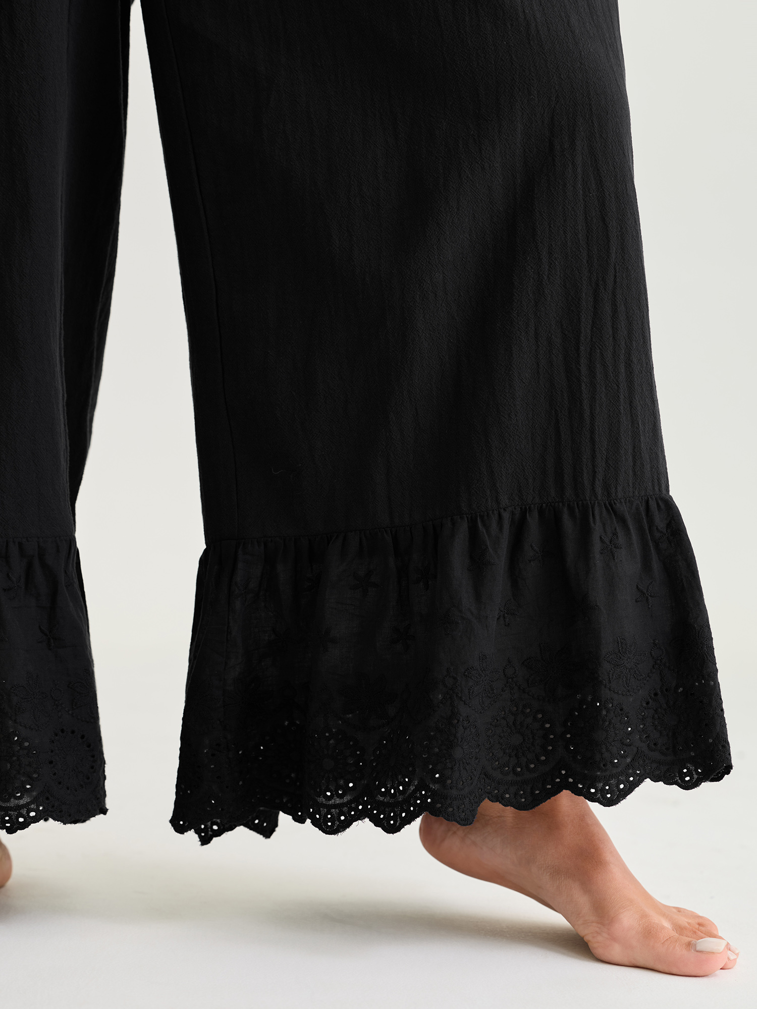 Side view of BloomChic Women's Plus Size Pure Cotton Ruffled Hem Lounge Bottoms Black Full 22-24/3X