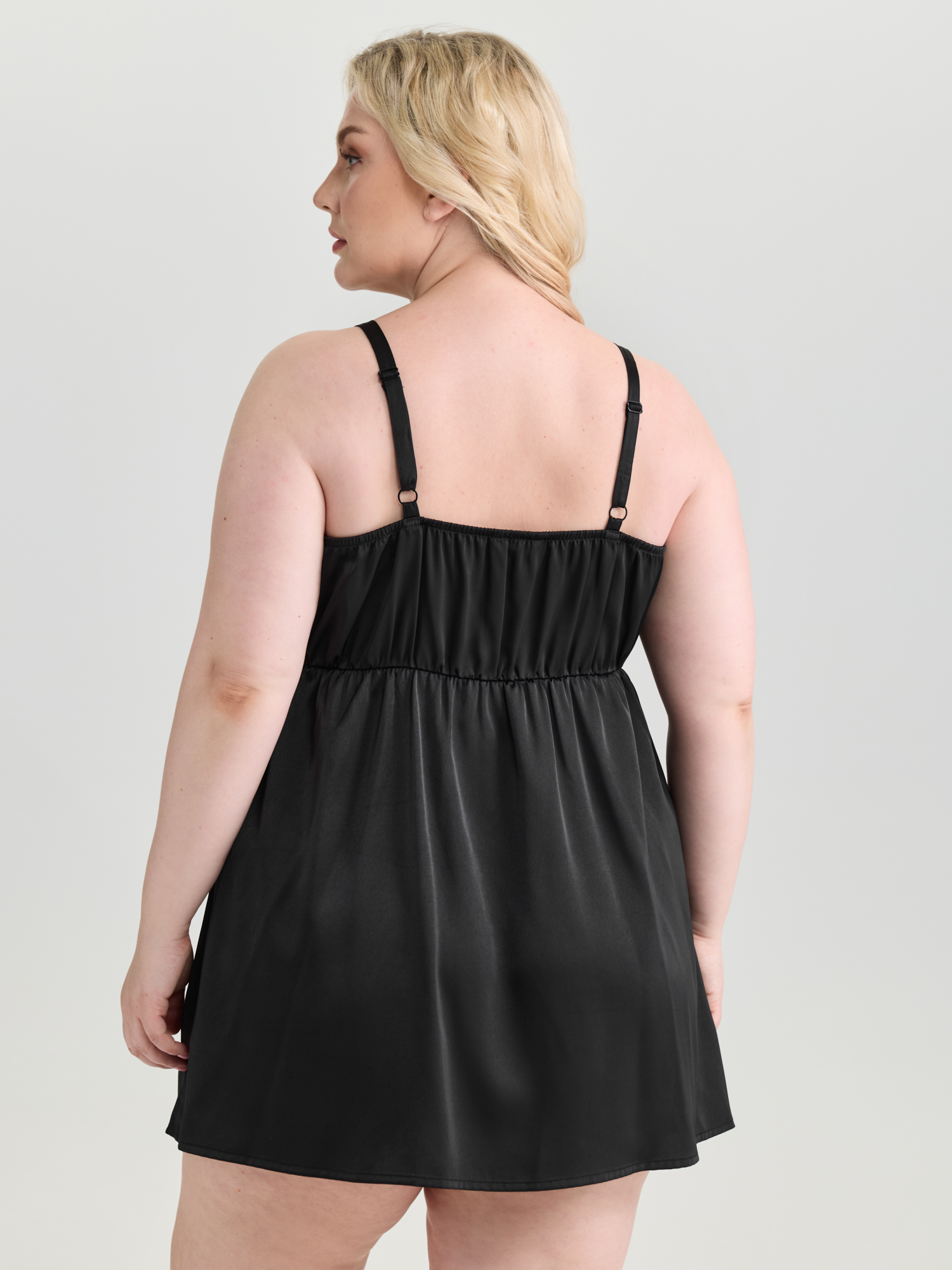 Side view of BloomChic Women's Plus Size Floral Embroidered Satin Bustier Nightgown Black Sleeveless Tunic 14-16/1X