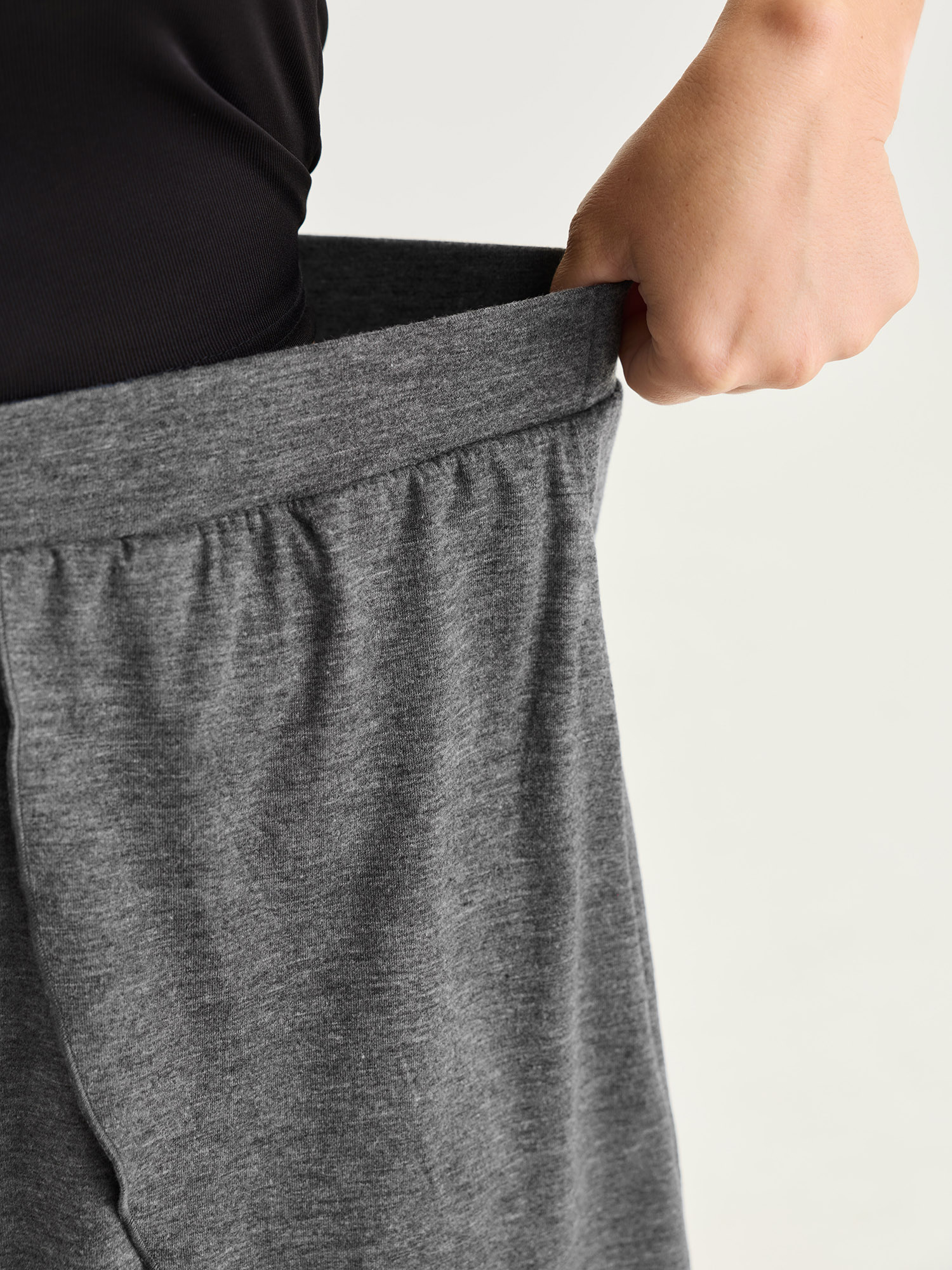 Side view of BloomChic Women's Plus Size Supersoft Stretchy Petal Hem Lounge Bottoms DimGray short 22-24/3X