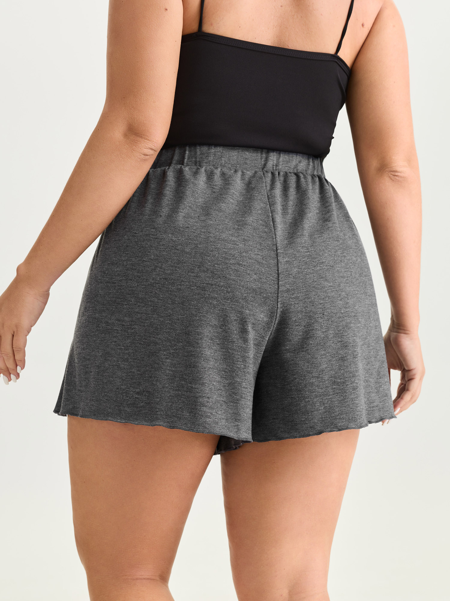 Side view of BloomChic Women's Plus Size Supersoft Stretchy Petal Hem Lounge Bottoms DimGray short 22-24/3X
