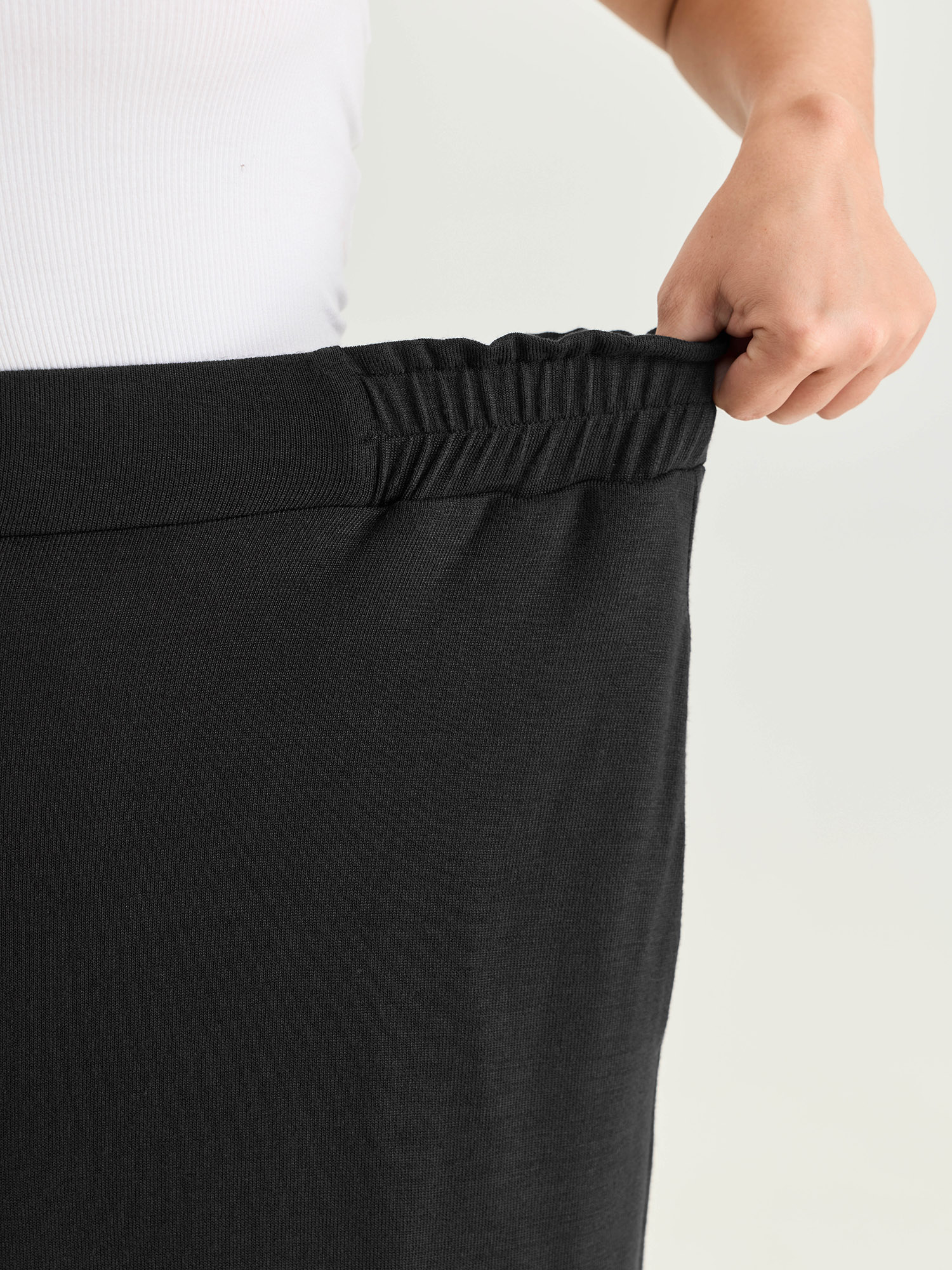 Side view of BloomChic Women's Plus Size Supersoft Elastic Waistband Lounge Bottoms Black Capri 18-20/2X