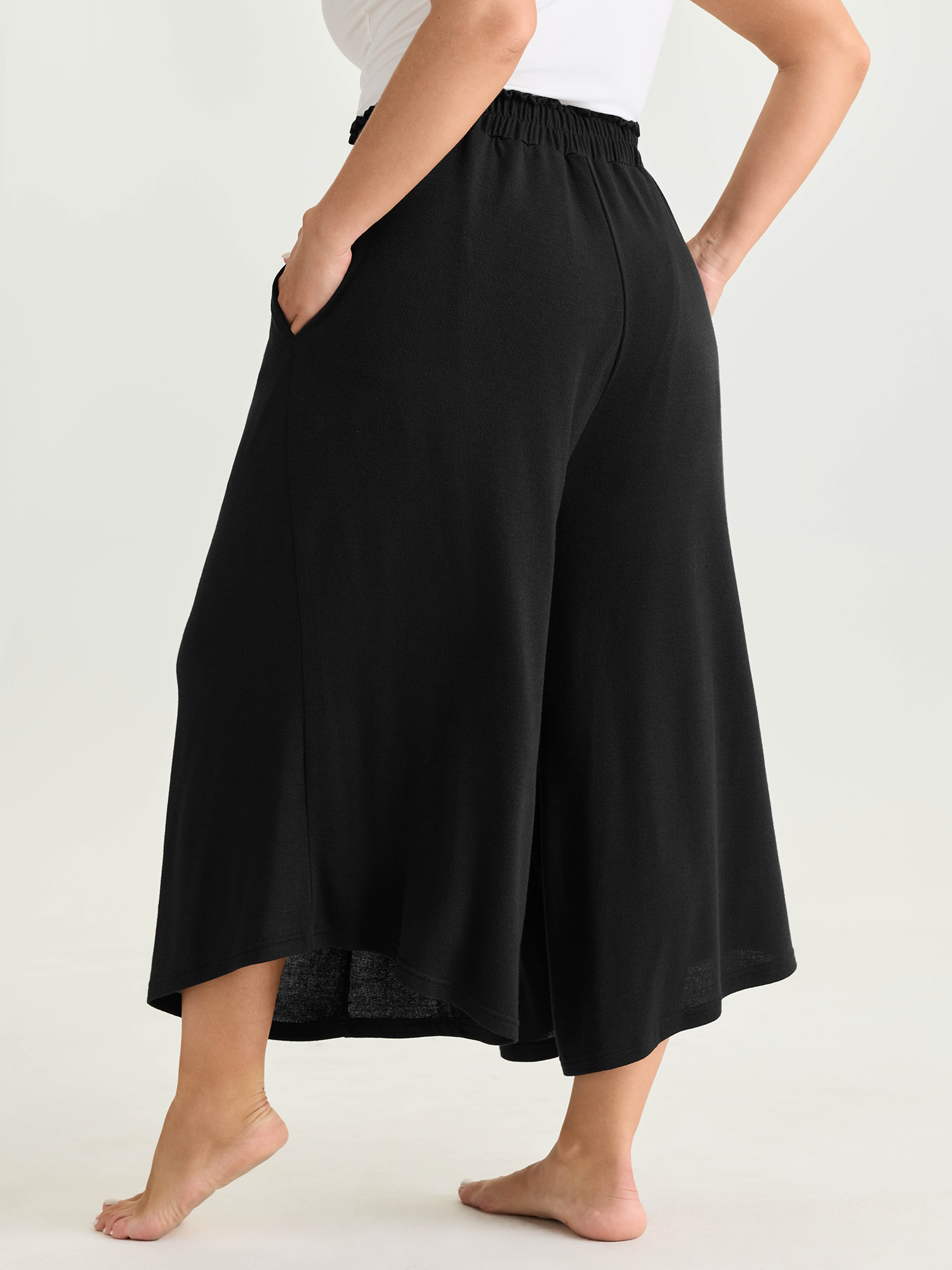 Side view of BloomChic Women's Plus Size Supersoft Elastic Waistband Lounge Bottoms Black Capri 18-20/2X