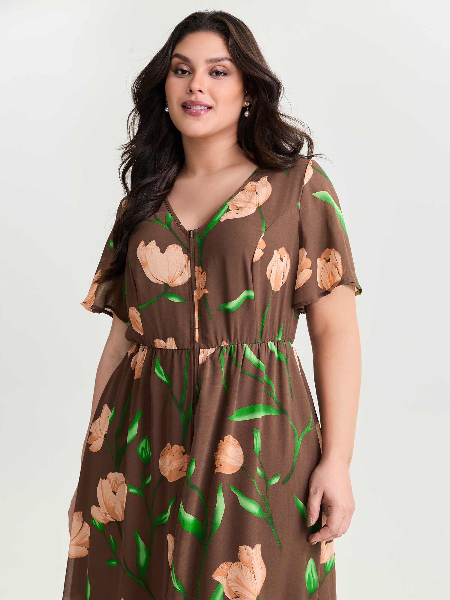 Side view of BloomChic Women's Plus Size Hidden Zipper Floral Layered Pockets Jumpsuit DarkBrown Elegant 30/6X