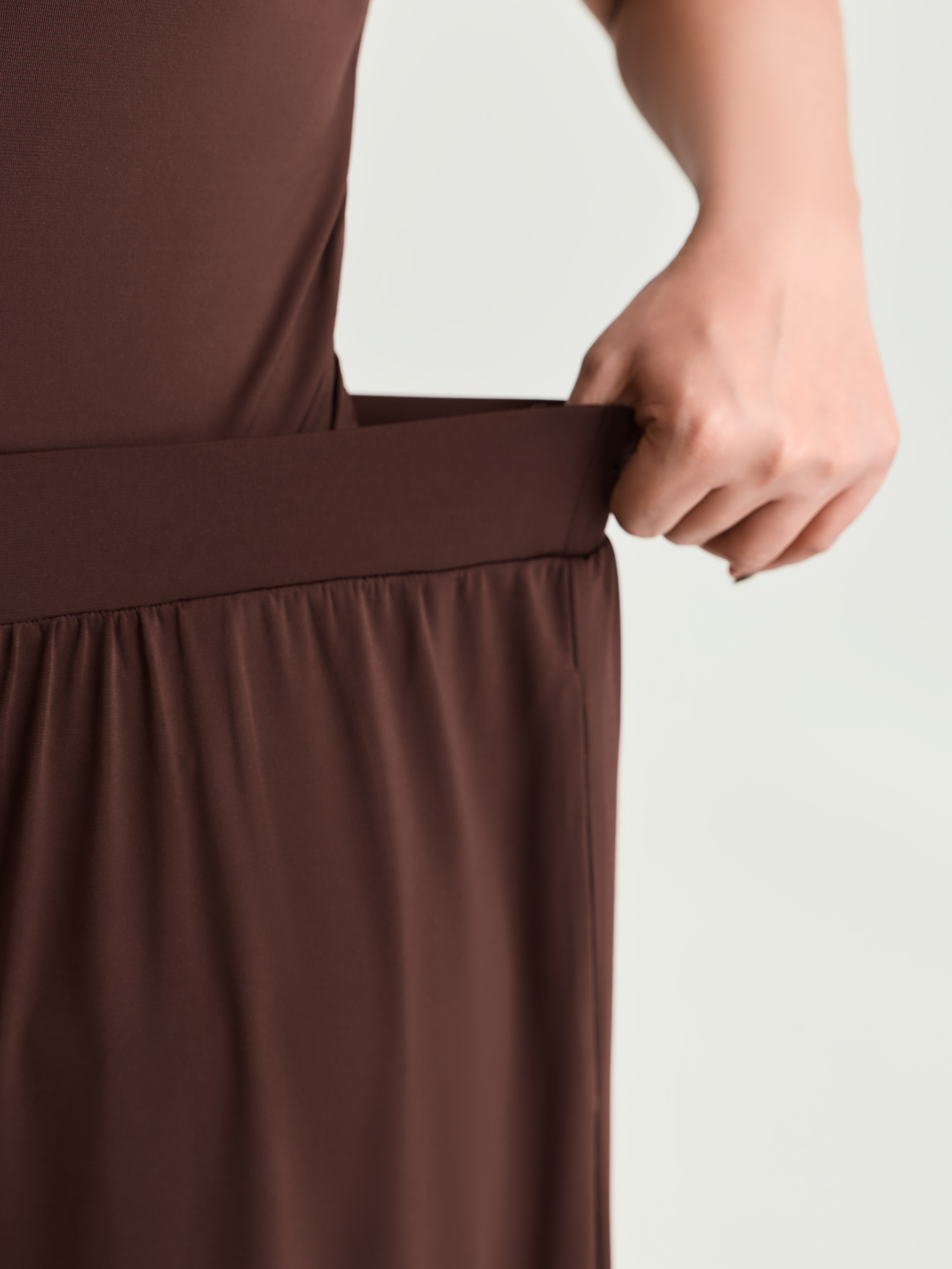 Side view of BloomChic Women's Plus Size Supersoft Stretchy Pleated Flared Plain Pants Browncoffeecolor Solid Flared Mid Rise Elegant 30/6X