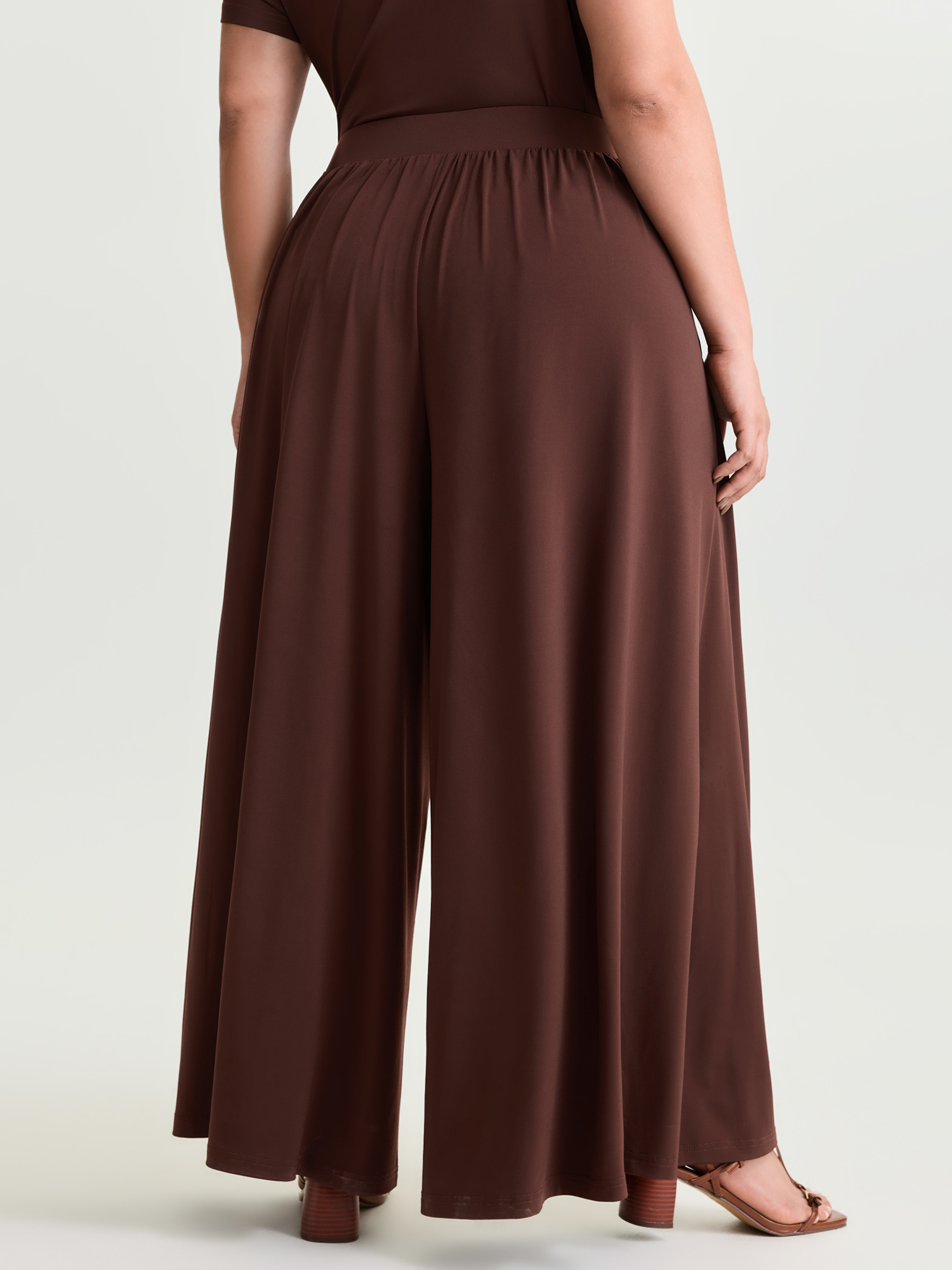 Side view of BloomChic Women's Plus Size Supersoft Stretchy Pleated Flared Plain Pants Browncoffeecolor Solid Flared Mid Rise Elegant 30/6X