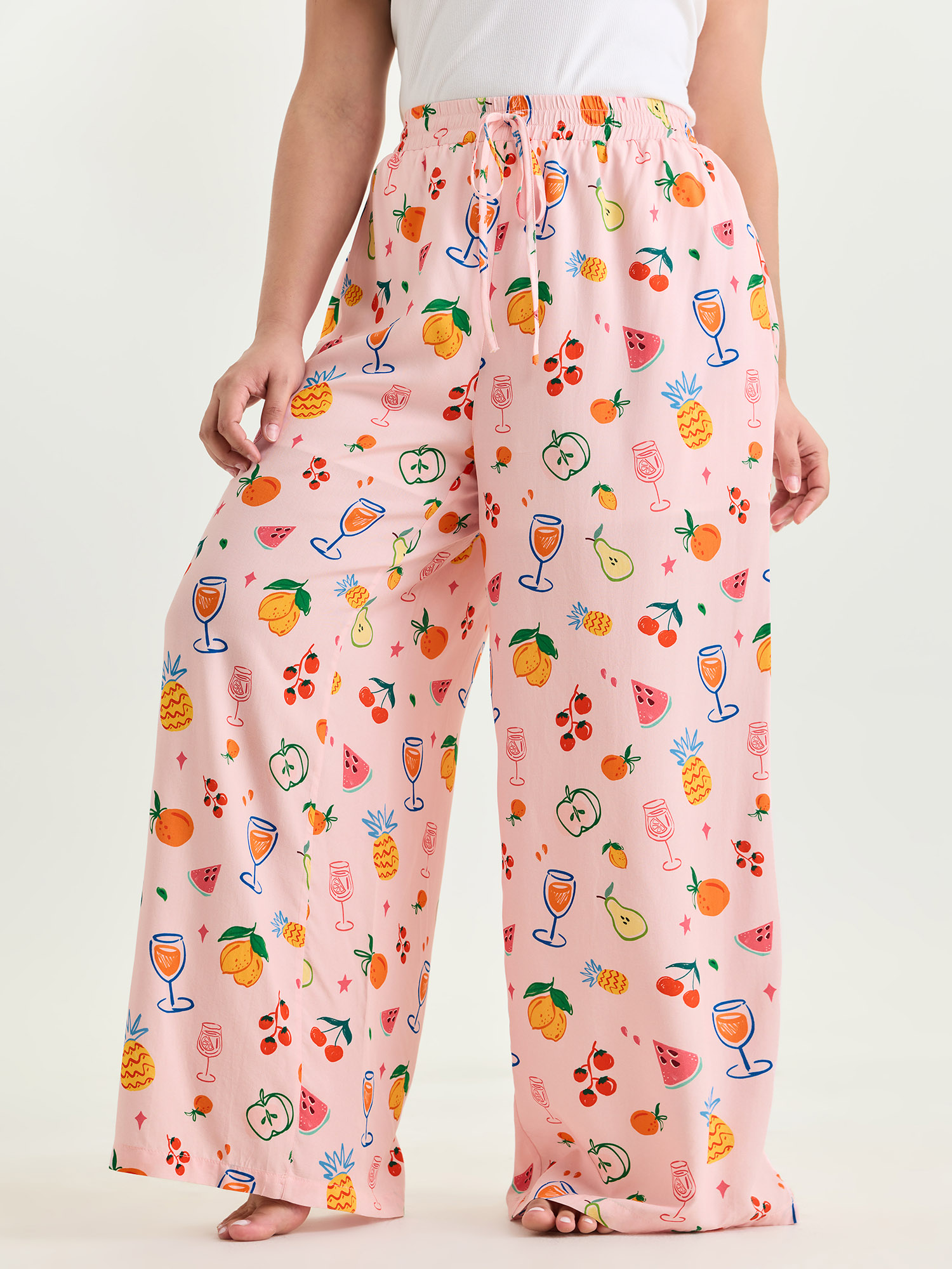 Side view of BloomChic Women's Plus Size Supersoft Playful Print Drawstring Pajama Bottoms Multicolor Fruit Lace-Up 26/4X