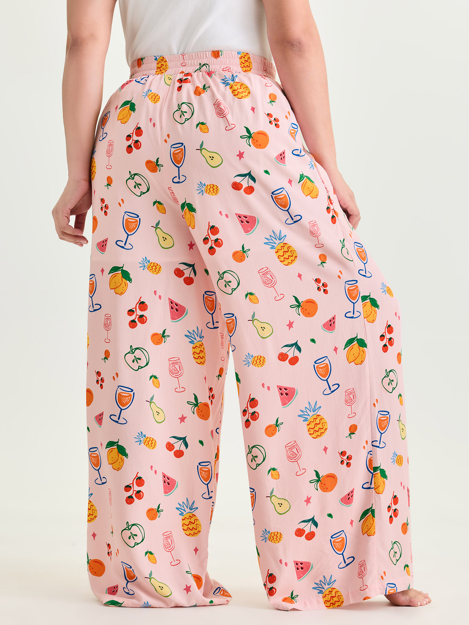 Side view of BloomChic Women's Plus Size Supersoft Playful Print Drawstring Pajama Bottoms Multicolor Fruit Lace-Up 26/4X