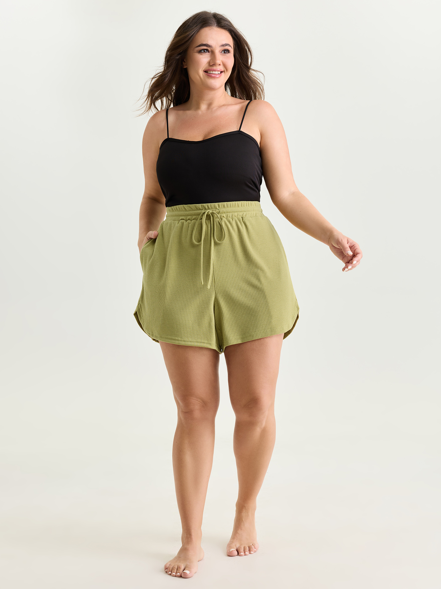Side view of BloomChic Women's Plus Size Supersoft Stretchy Textured Drawstring Lounge Bottoms Mustardyellow short 28/5X