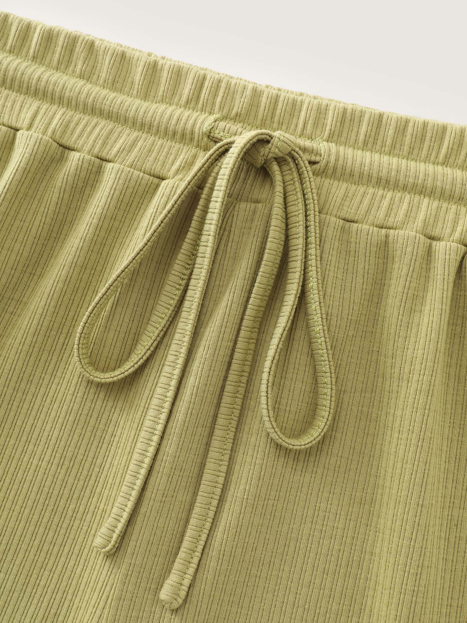 Side view of BloomChic Women's Plus Size Supersoft Stretchy Textured Drawstring Lounge Bottoms Mustardyellow short 28/5X