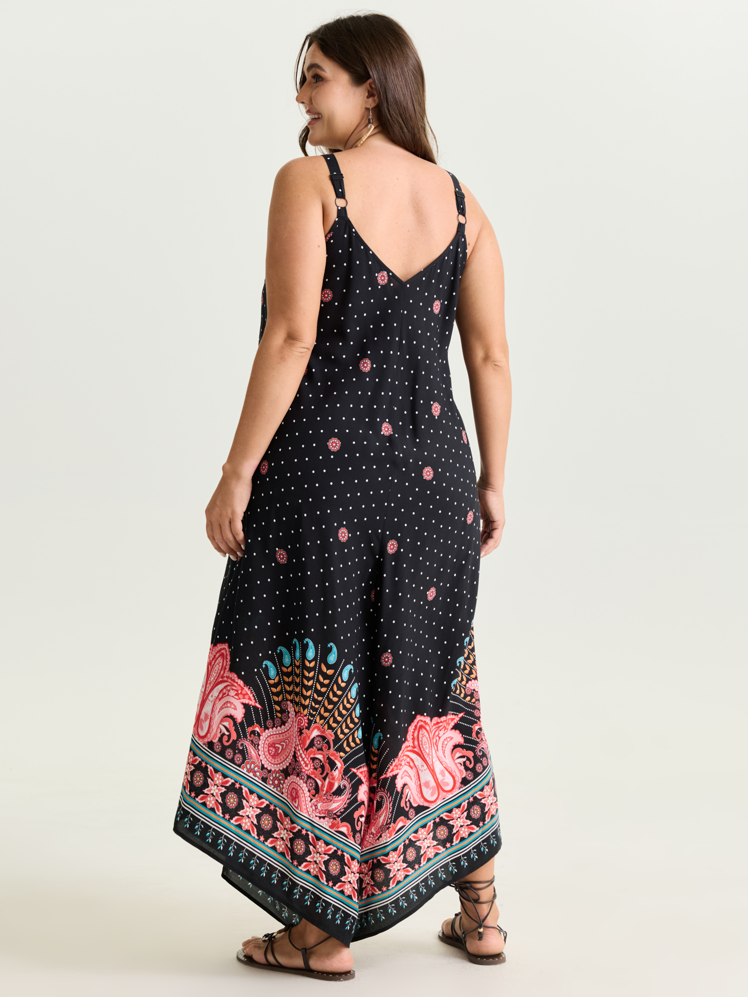Side view of BloomChic Women's Plus Size Boho Print Asymmetrical Hem Jumpsuit Multicolor Vacation 22-24/3X
