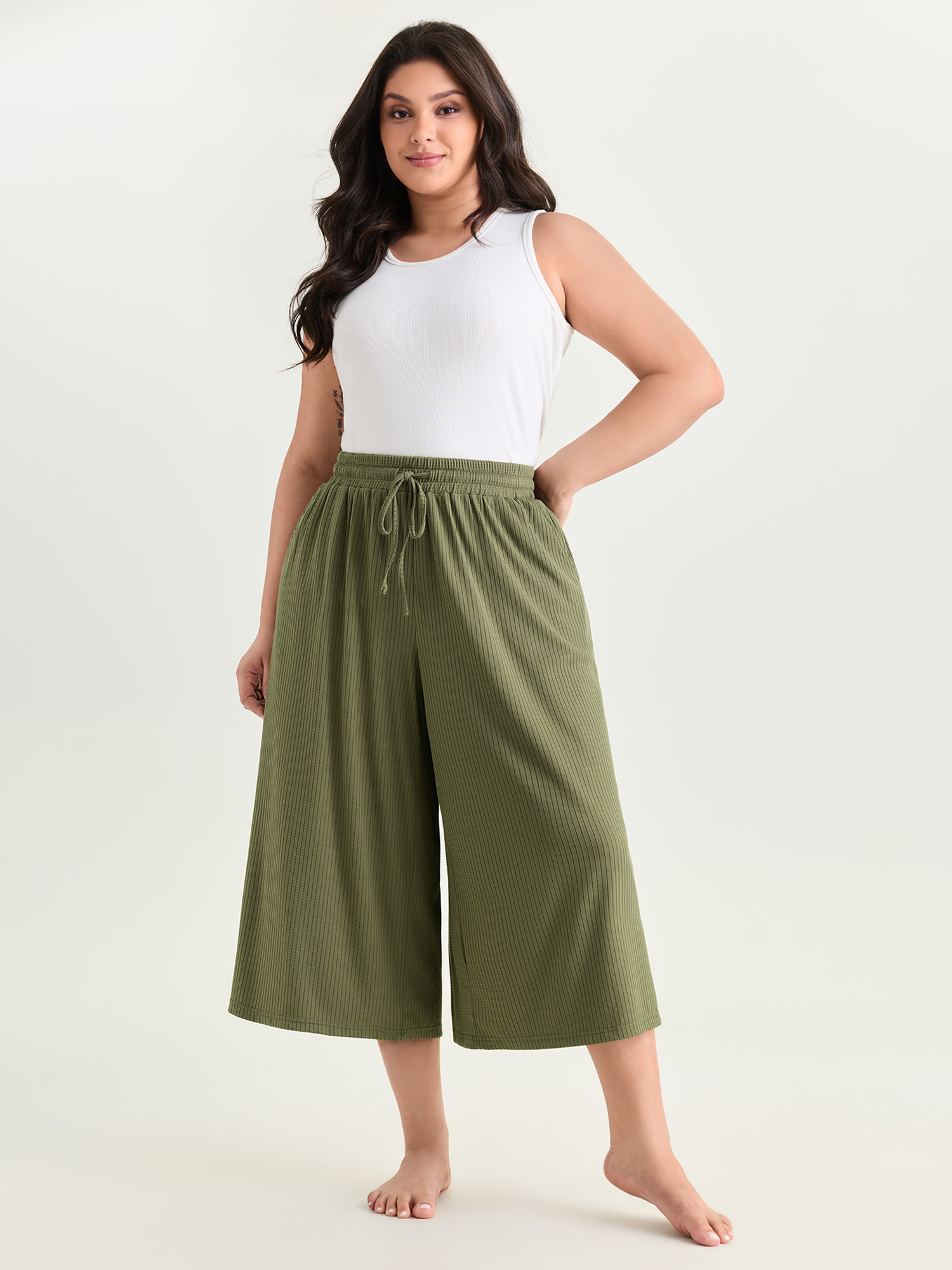 Side view of BloomChic Women's Plus Size Supersoft Stretchy Textured Elastic Waist Lounge Bottoms Sage Capri 30/6X