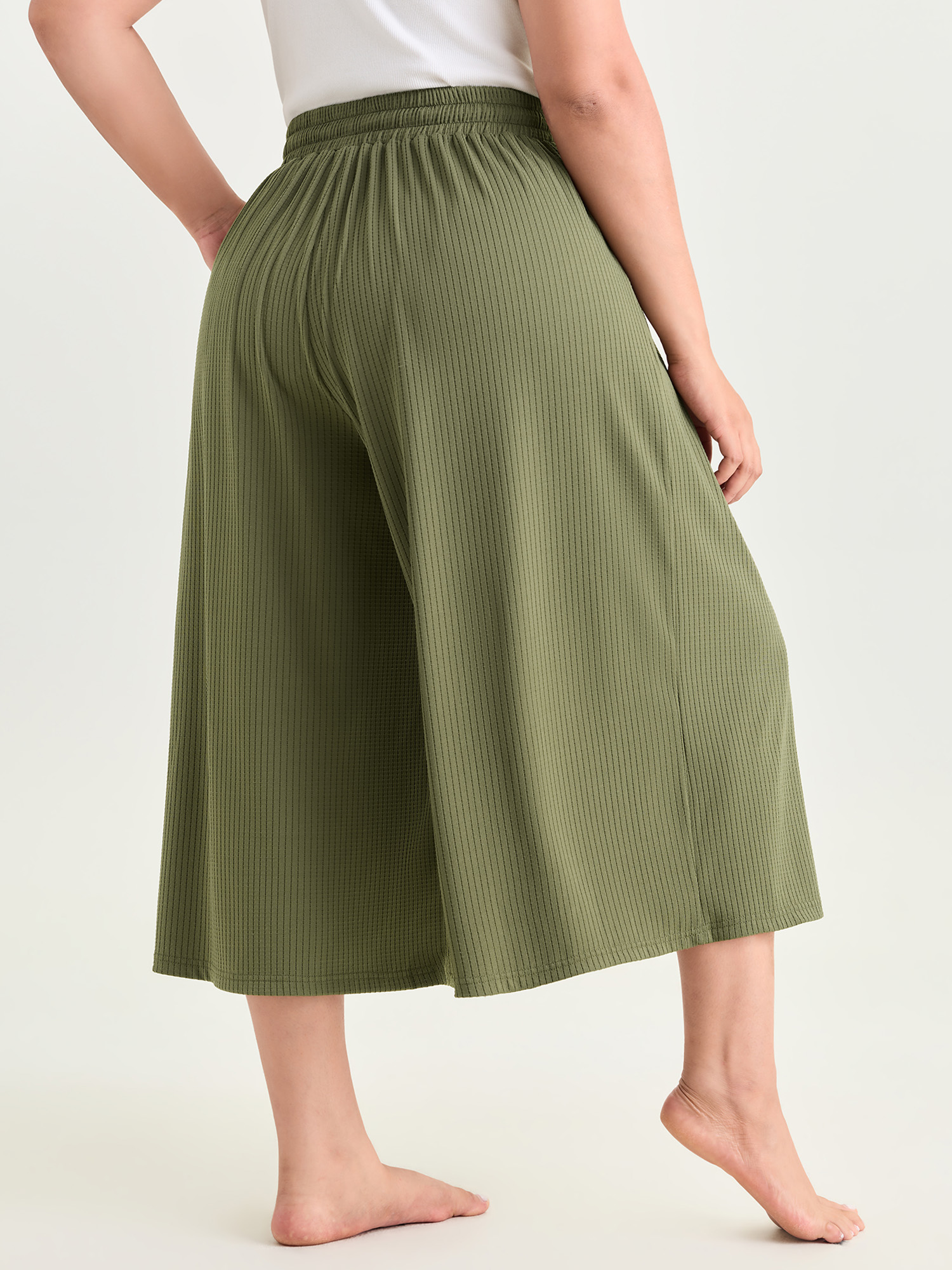 Side view of BloomChic Women's Plus Size Supersoft Stretchy Textured Elastic Waist Lounge Bottoms Sage Capri 30/6X