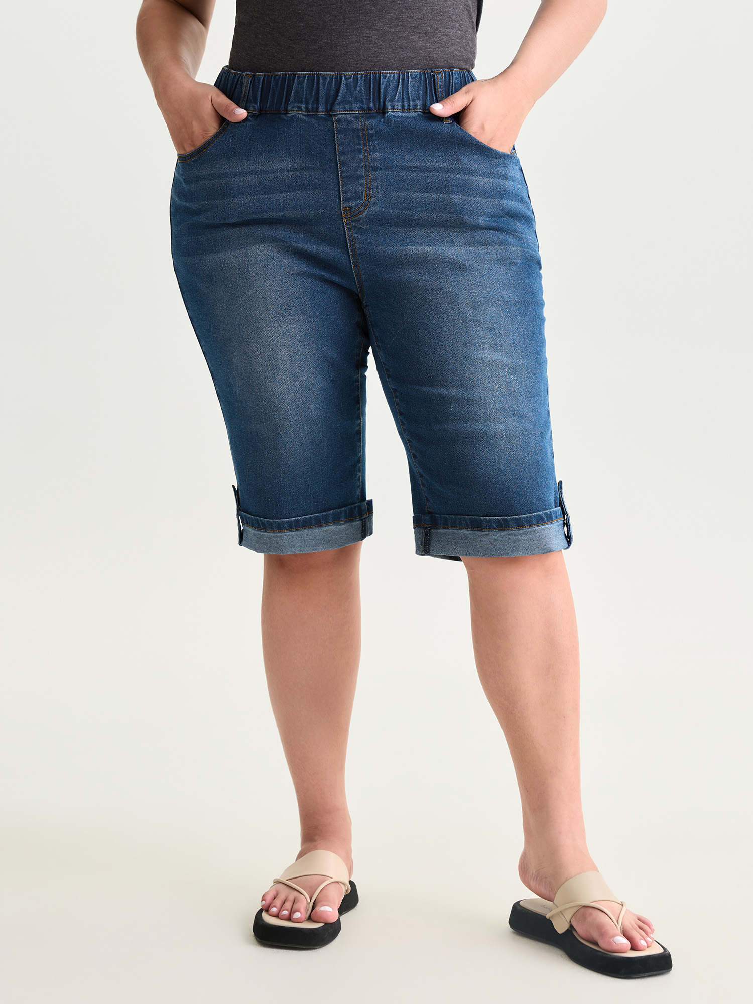 Side view of BloomChic Women's Plus Size Pull-On Stretchy Denim Shorts Mediumblue Non High Rise Casual 30/6X