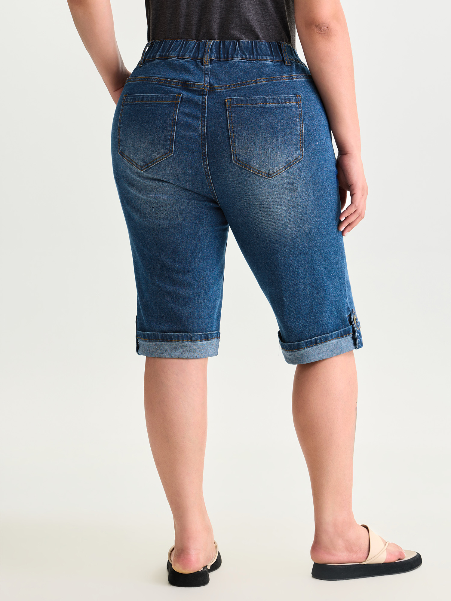 Side view of BloomChic Women's Plus Size Pull-On Stretchy Denim Shorts Mediumblue Non High Rise Casual 30/6X