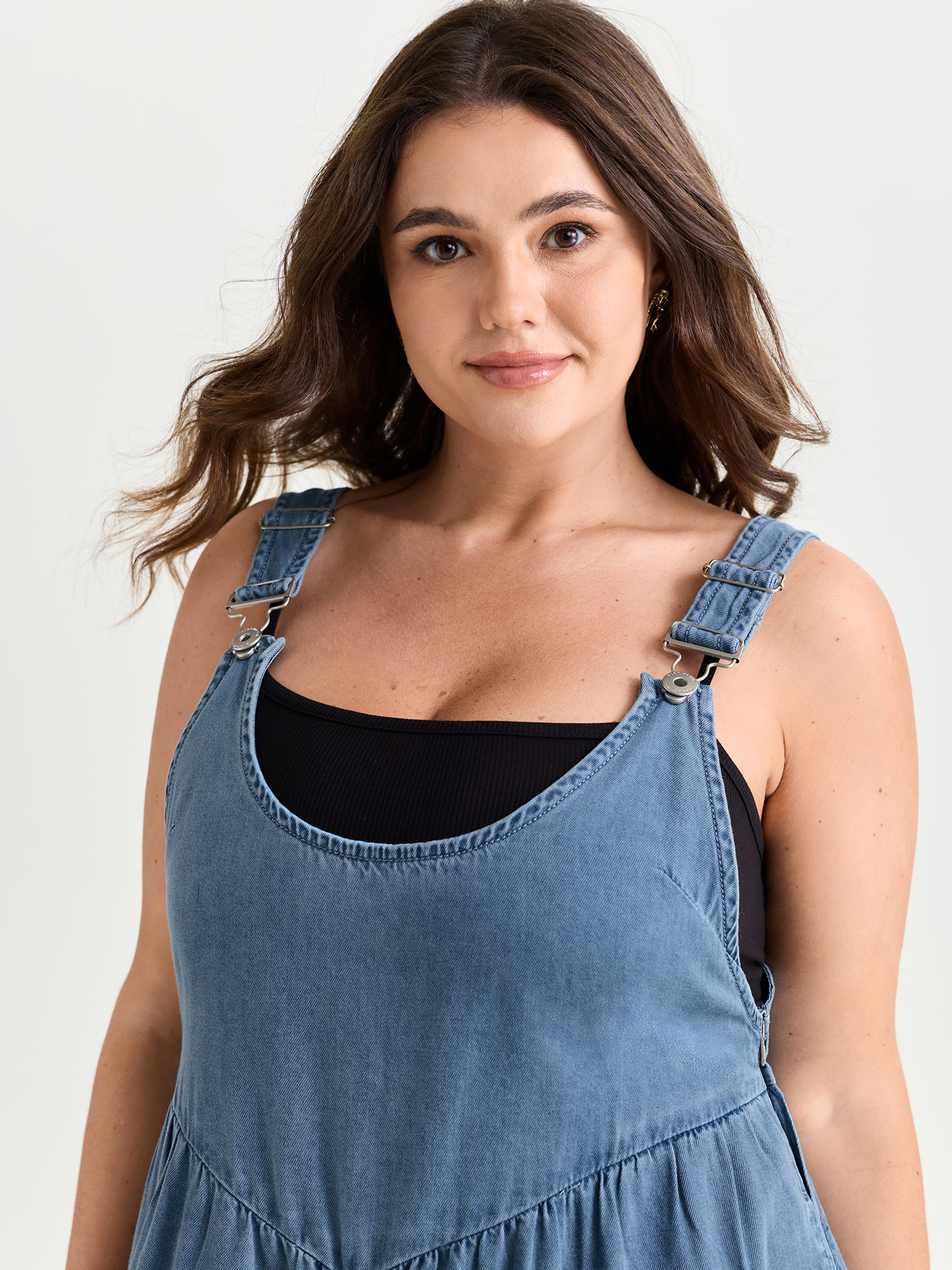 Side view of BloomChic Women's Plus Size Pleated Adjustable Overall Straps Denim Jumpsuit Denimlightblue Casual 10/M