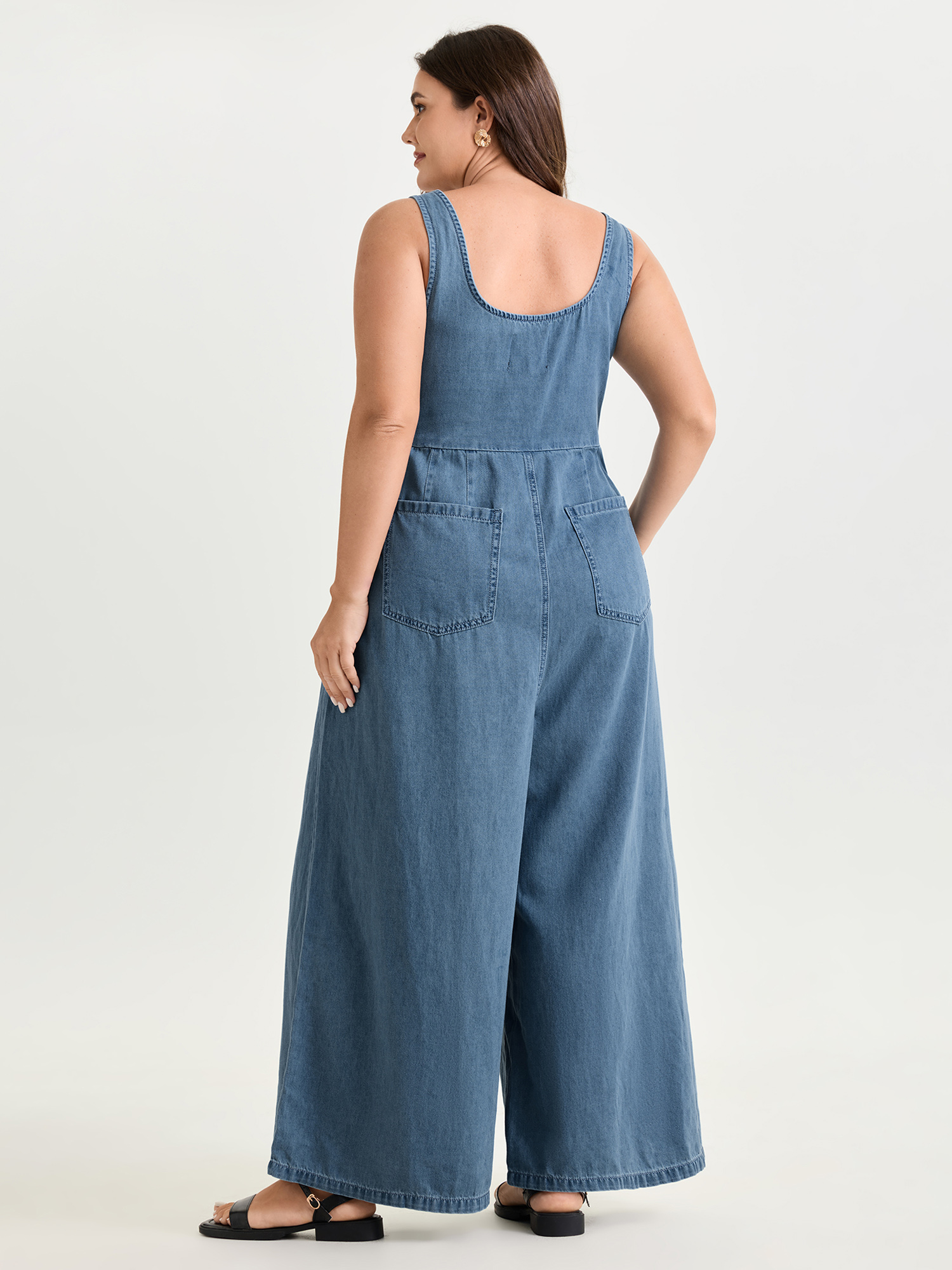 Side view of BloomChic Women's Plus Size Pleated Adjustable Overall Straps Denim Jumpsuit Denimlightblue Casual 10/M