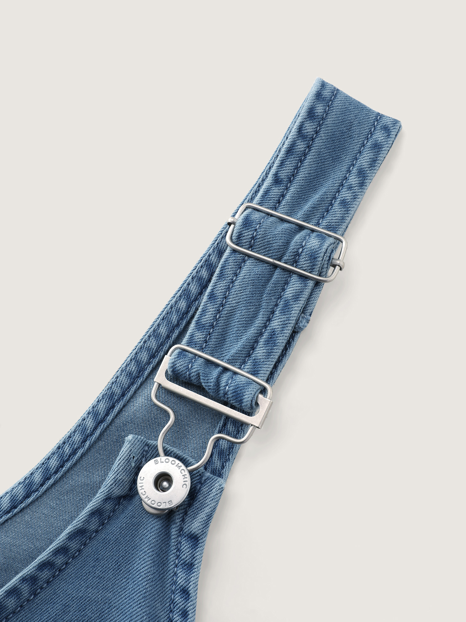 Side view of BloomChic Women's Plus Size Pleated Adjustable Overall Straps Denim Jumpsuit Denimlightblue Casual 10/M