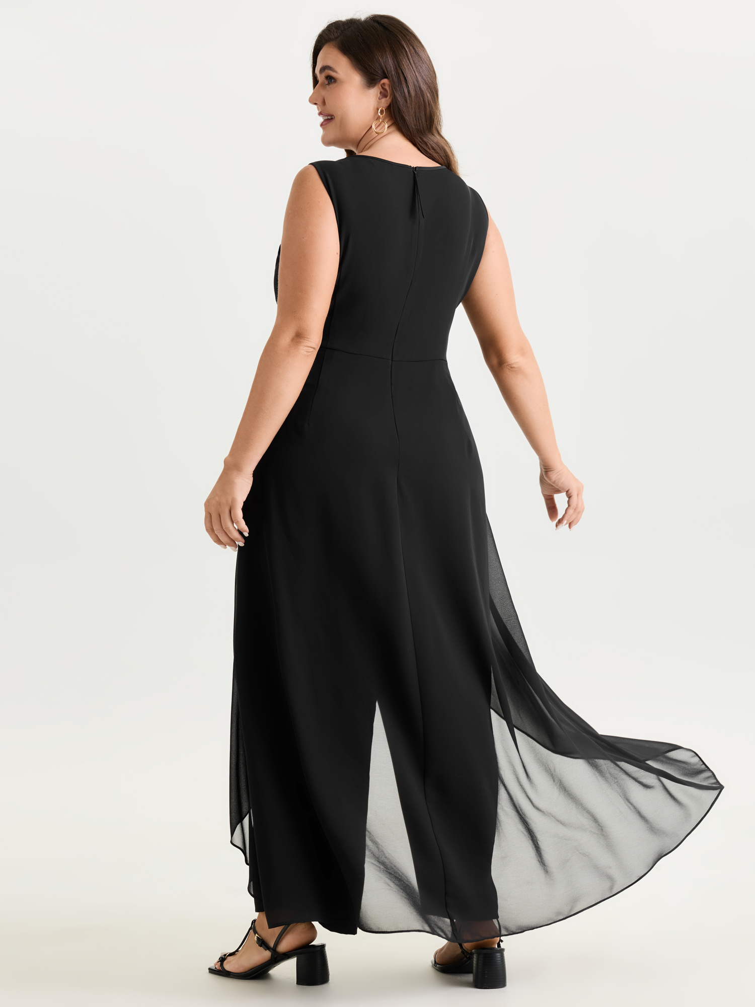 Side view of BloomChic Women's Plus Size Stretchy Sheer Layered Sleeveless Jumpsuit Black Elegant 30/6X