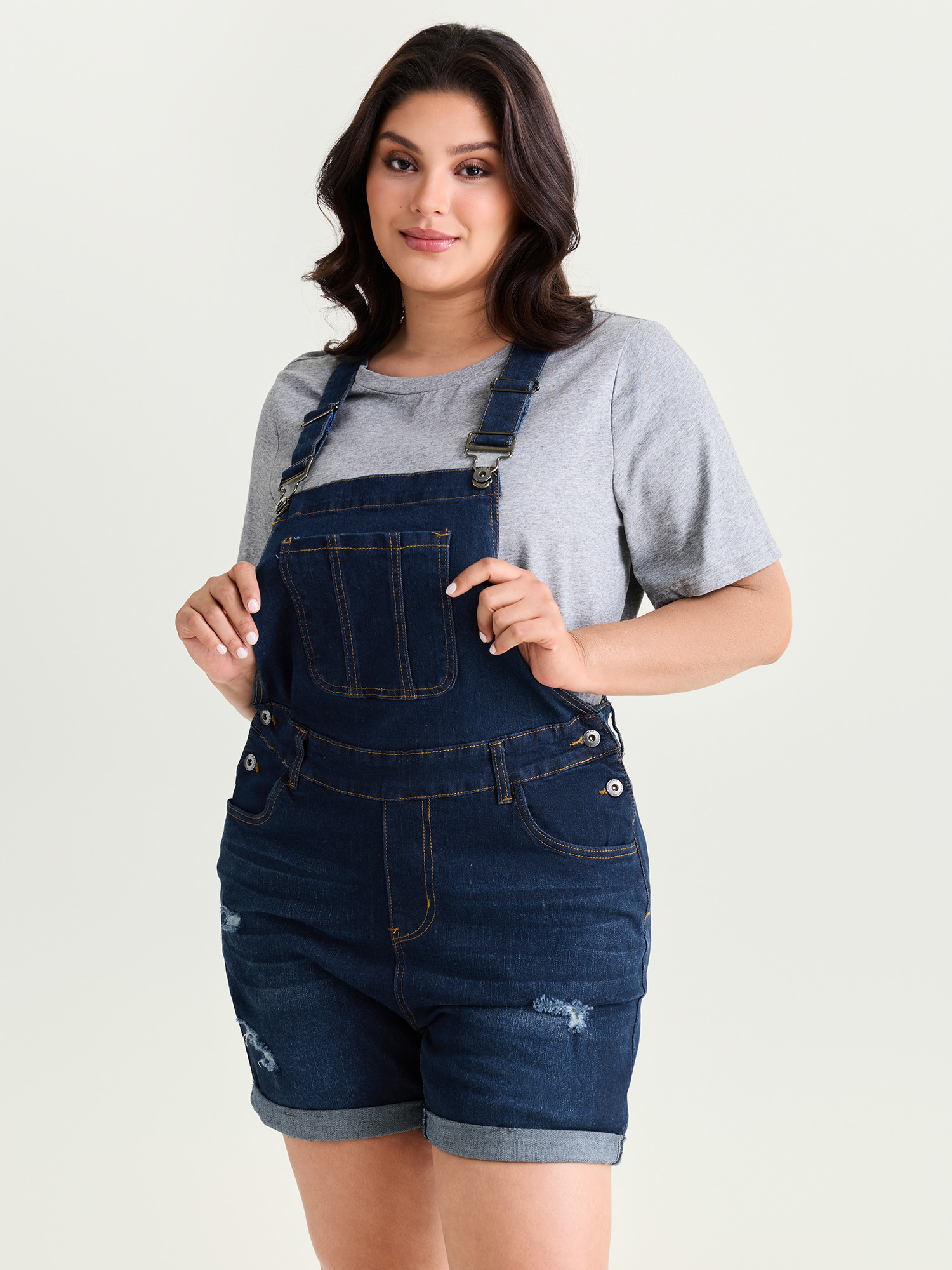 Side view of BloomChic Women's Plus Size Stretchy Pockets Skinny-Fit Denim Overall Romper Darkindigo Casual 28/5X