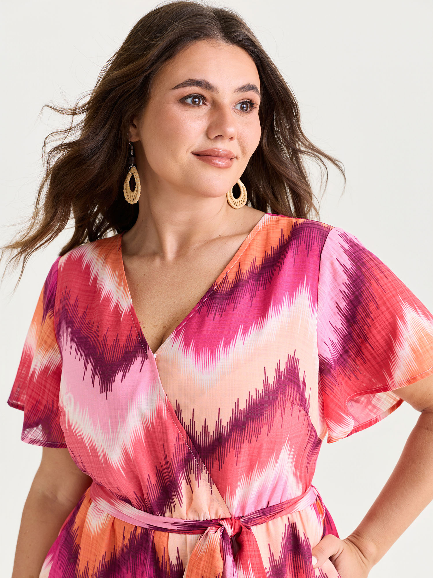 Side view of BloomChic Women's Plus Size Geometric Print Wrap Side-Tie Jumpsuit Multicolor Vacation Relaxed Fit 30/6X