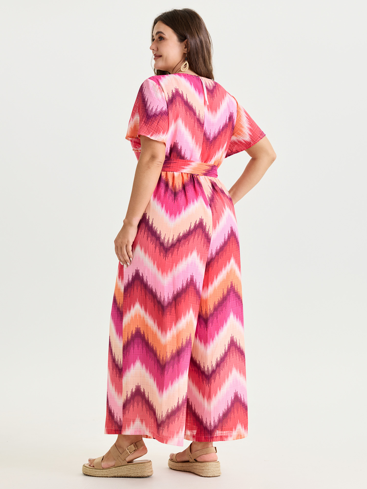 Side view of BloomChic Women's Plus Size Geometric Print Wrap Side-Tie Jumpsuit Multicolor Vacation Relaxed Fit 30/6X