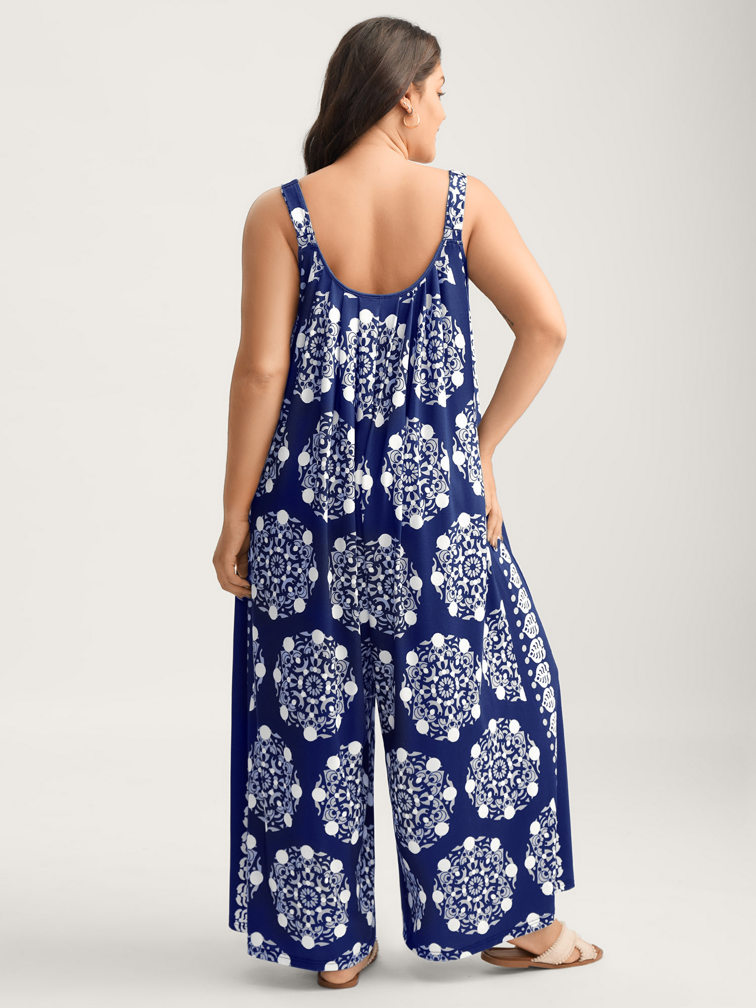 Side view of BloomChic Women's Plus Size Sunkissed Stretchy Adjustable Strap Jumpsuit Midnight Vacation Baggy 18-20/2X