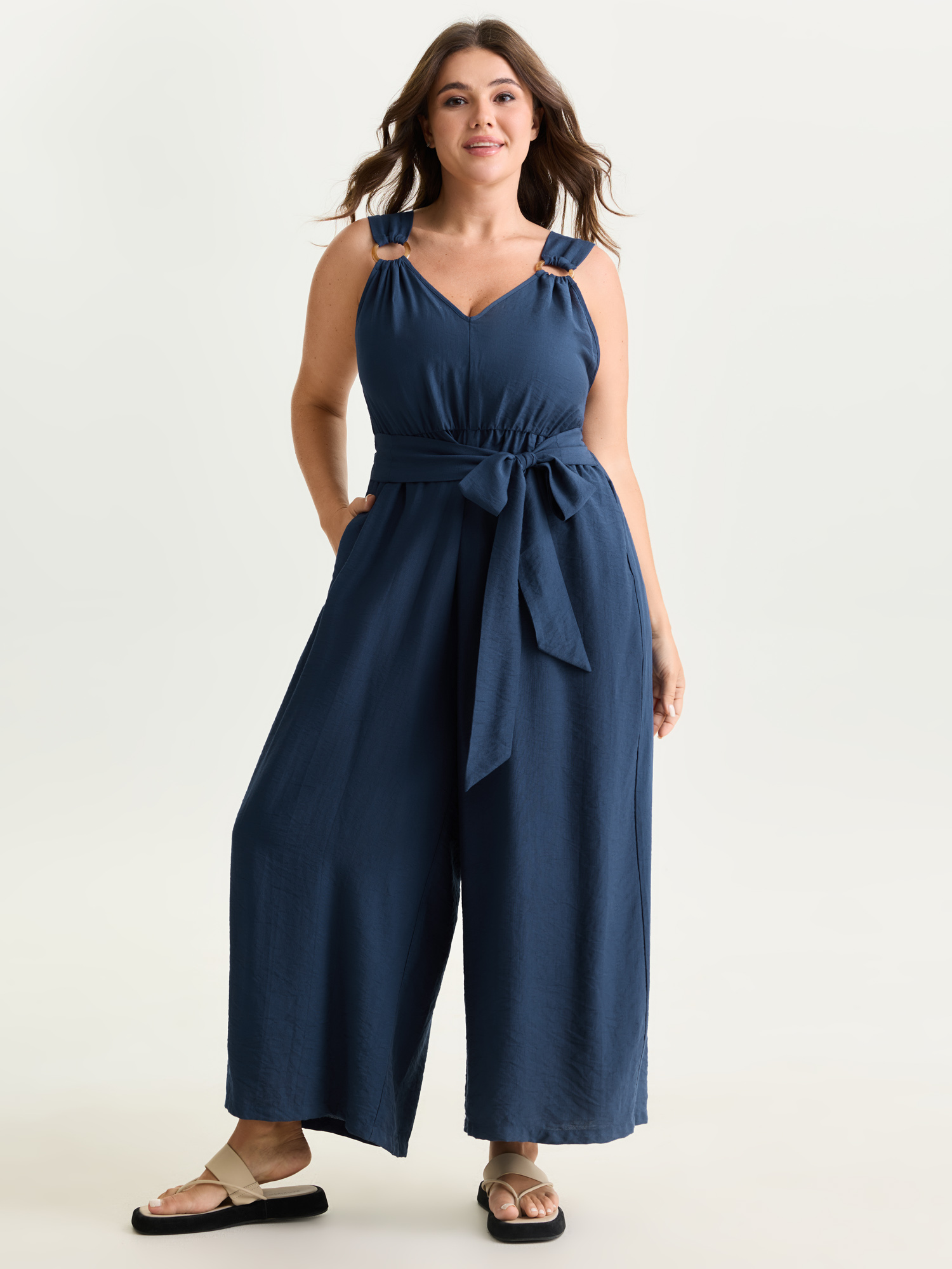Side view of BloomChic Women's Plus Size Adjustable Waist-Tie Overall Jumpsuit Indigo Casual 12/L