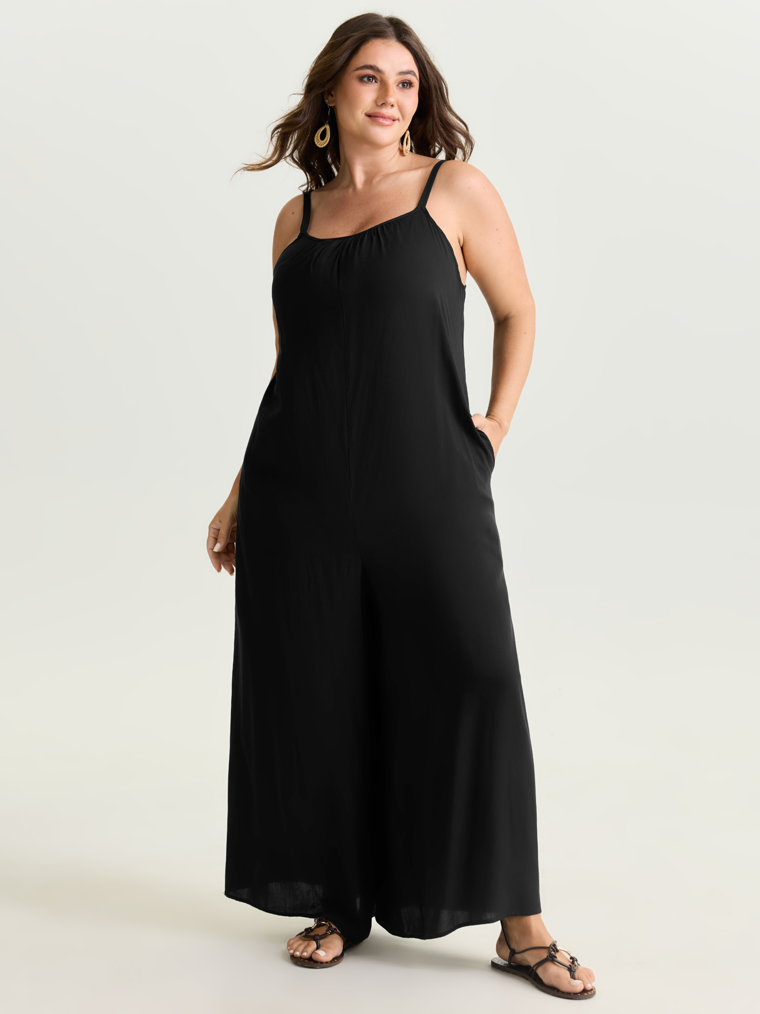 Side view of BloomChic Women's Plus Size Backless Inclusive Flowy Fit Plain Lounge Jumpsuit Black 22-24/3X