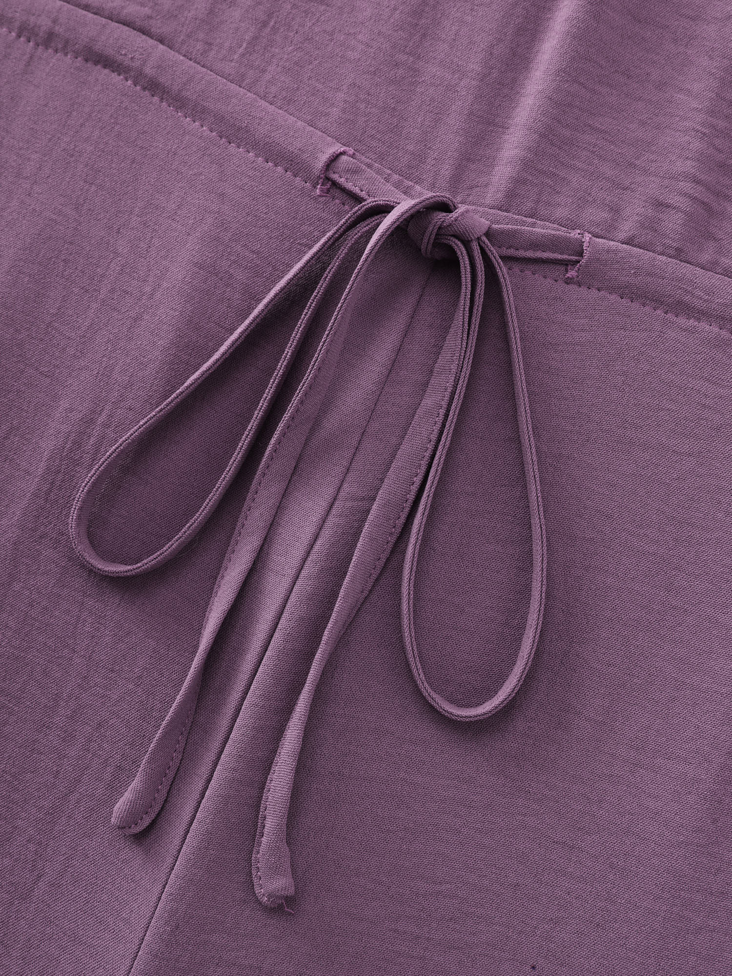 Side view of BloomChic Women's Plus Size Ruffled Drawstring Waist Flowy Jumpsuit Mauve Vacation 10/M