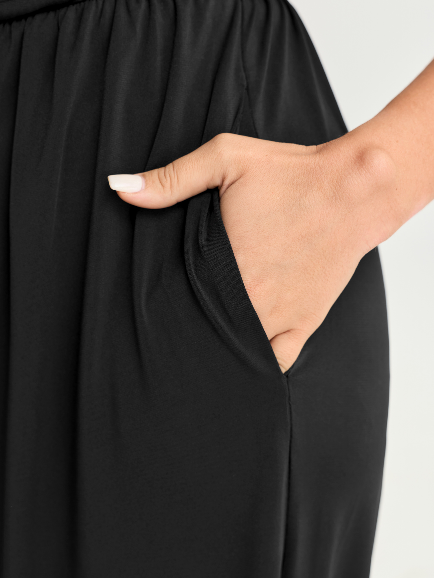 Side view of BloomChic Women's Plus Size Supported Bra Off-Shoulder Stretchy Pockets Jumpsuit Black Vacation 14-16/1X