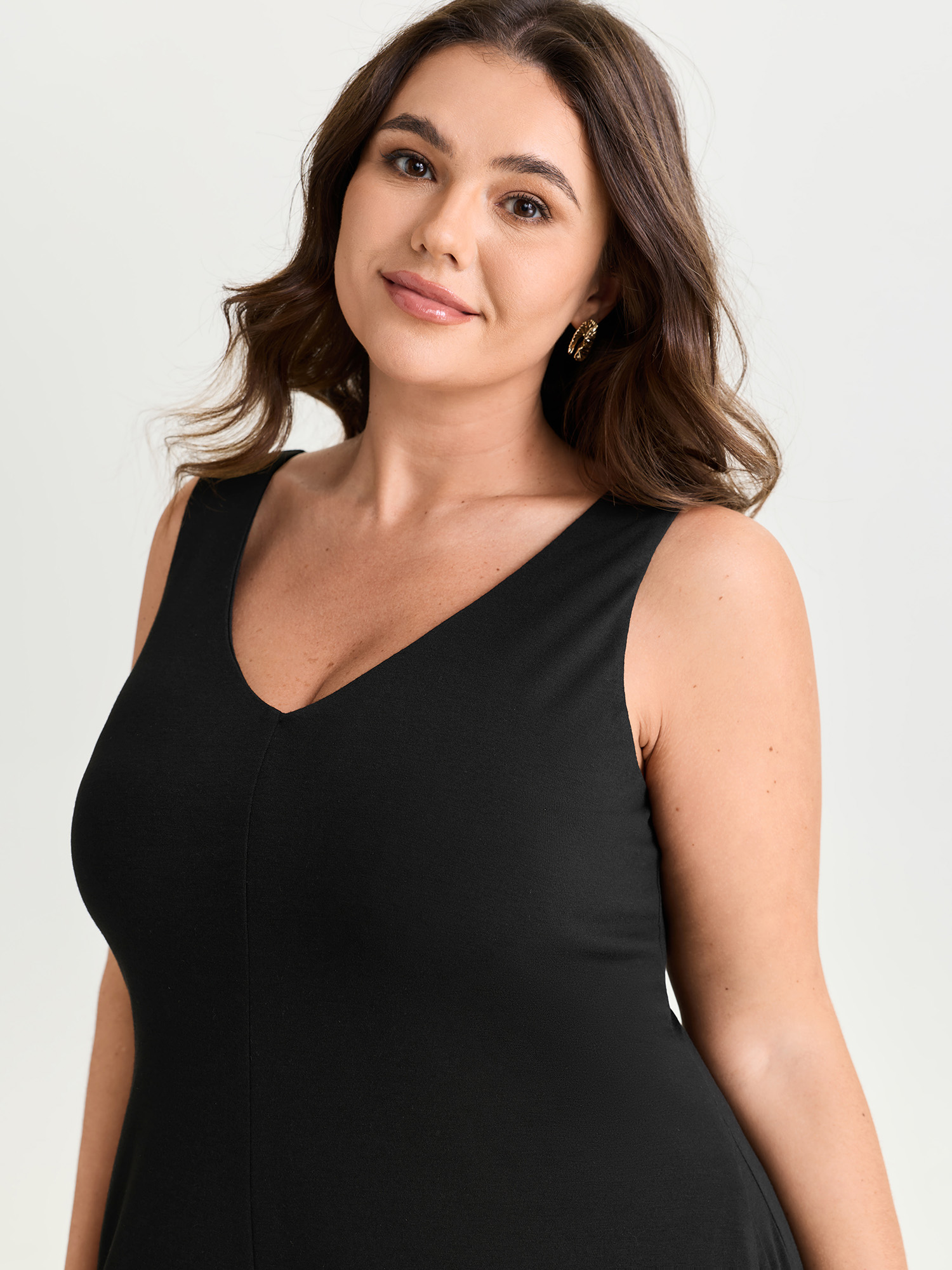 Side view of BloomChic Women's Plus Size Stretchy Deep Back Neckline Jumpsuit Black Casual 30/6X