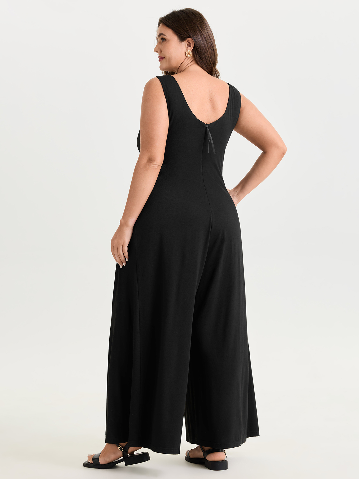 Side view of BloomChic Women's Plus Size Stretchy Deep Back Neckline Jumpsuit Black Casual 30/6X