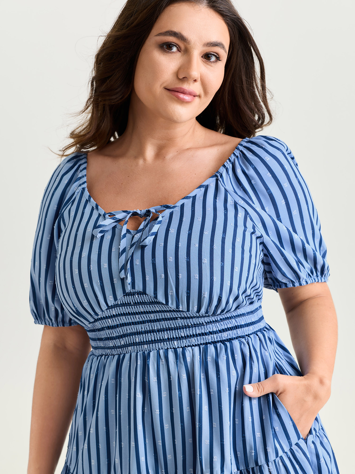 Side view of BloomChic Women's Plus Size Striped Print Neck-Tie Tiered Mini Dress Skyblue Stripes Knee Length Casual Smocked 30/6X