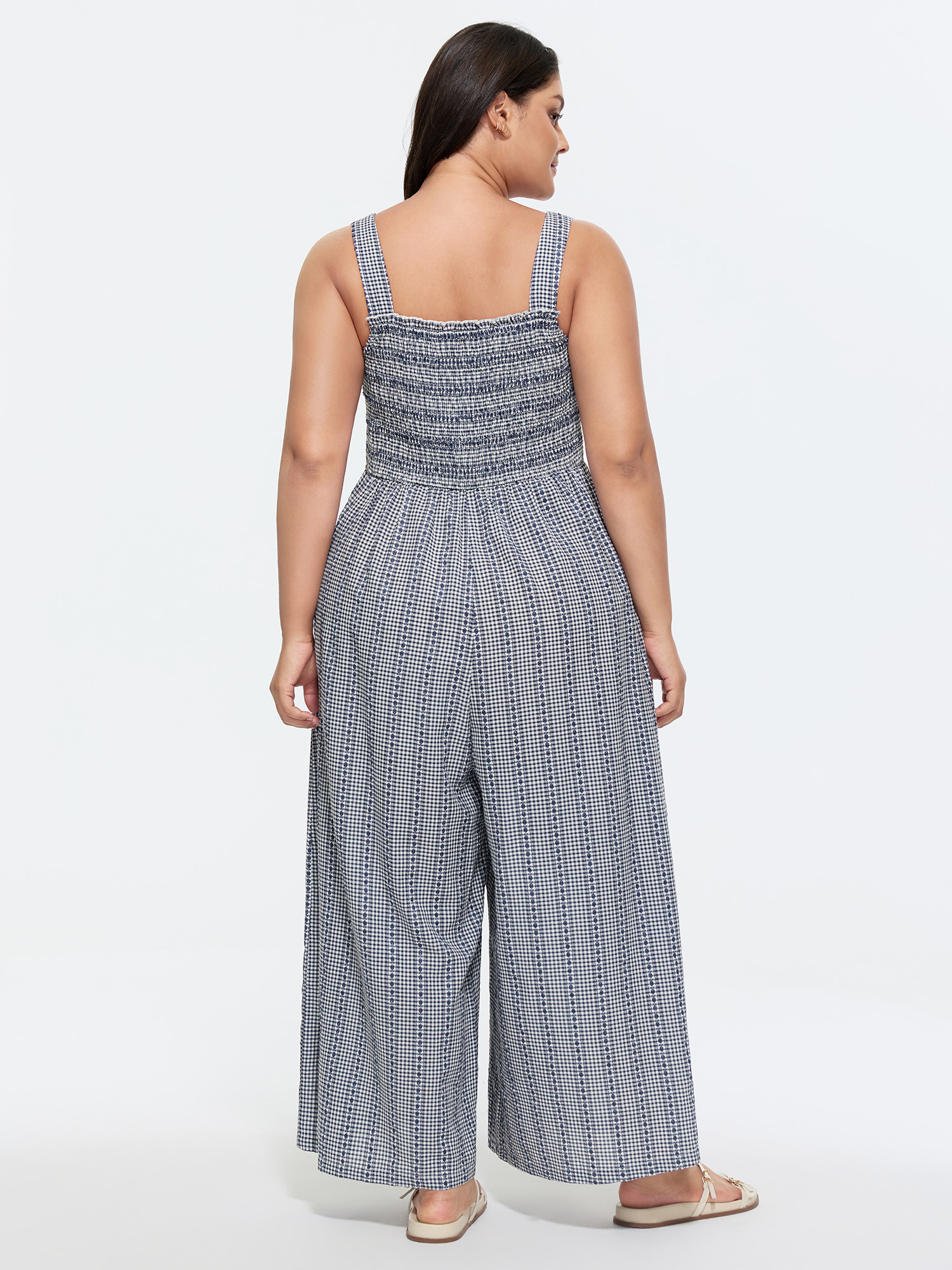 Side view of BloomChic Women's Plus Size Striped Print Shirred Wide-Straps Jumpsuit Indigo Casual 10/M