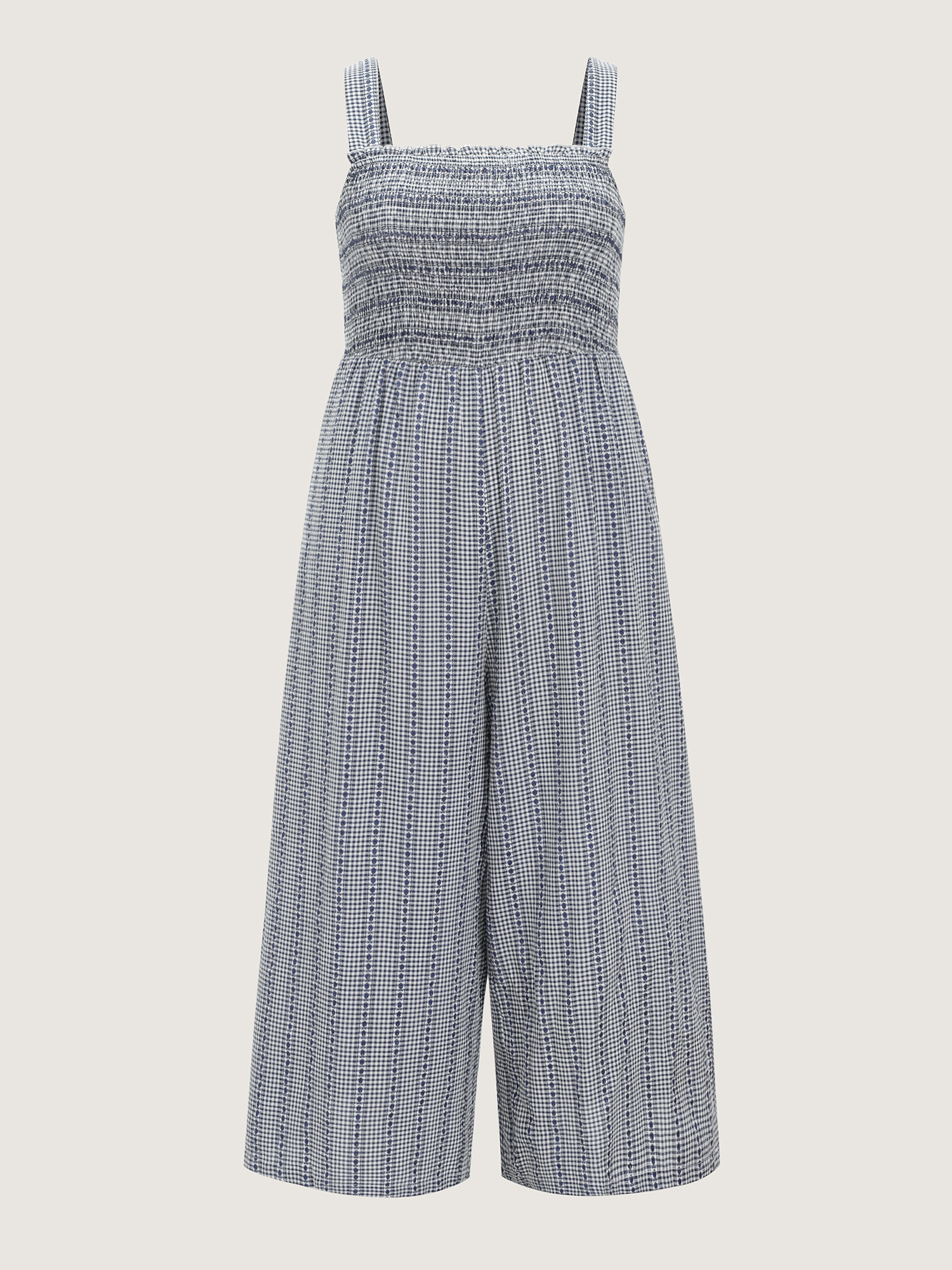 Side view of BloomChic Women's Plus Size Striped Print Shirred Wide-Straps Jumpsuit Indigo Casual 10/M
